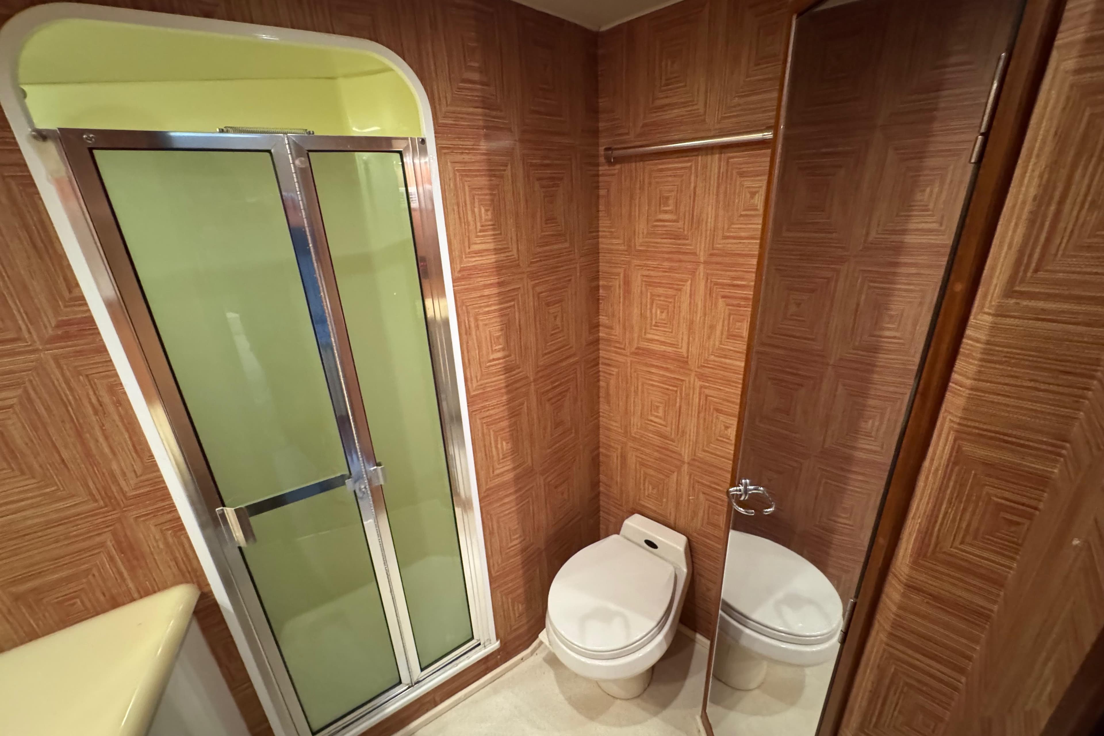 Bathroom interior of 1995 Viking 58 Convertible yacht with shower and toilet.