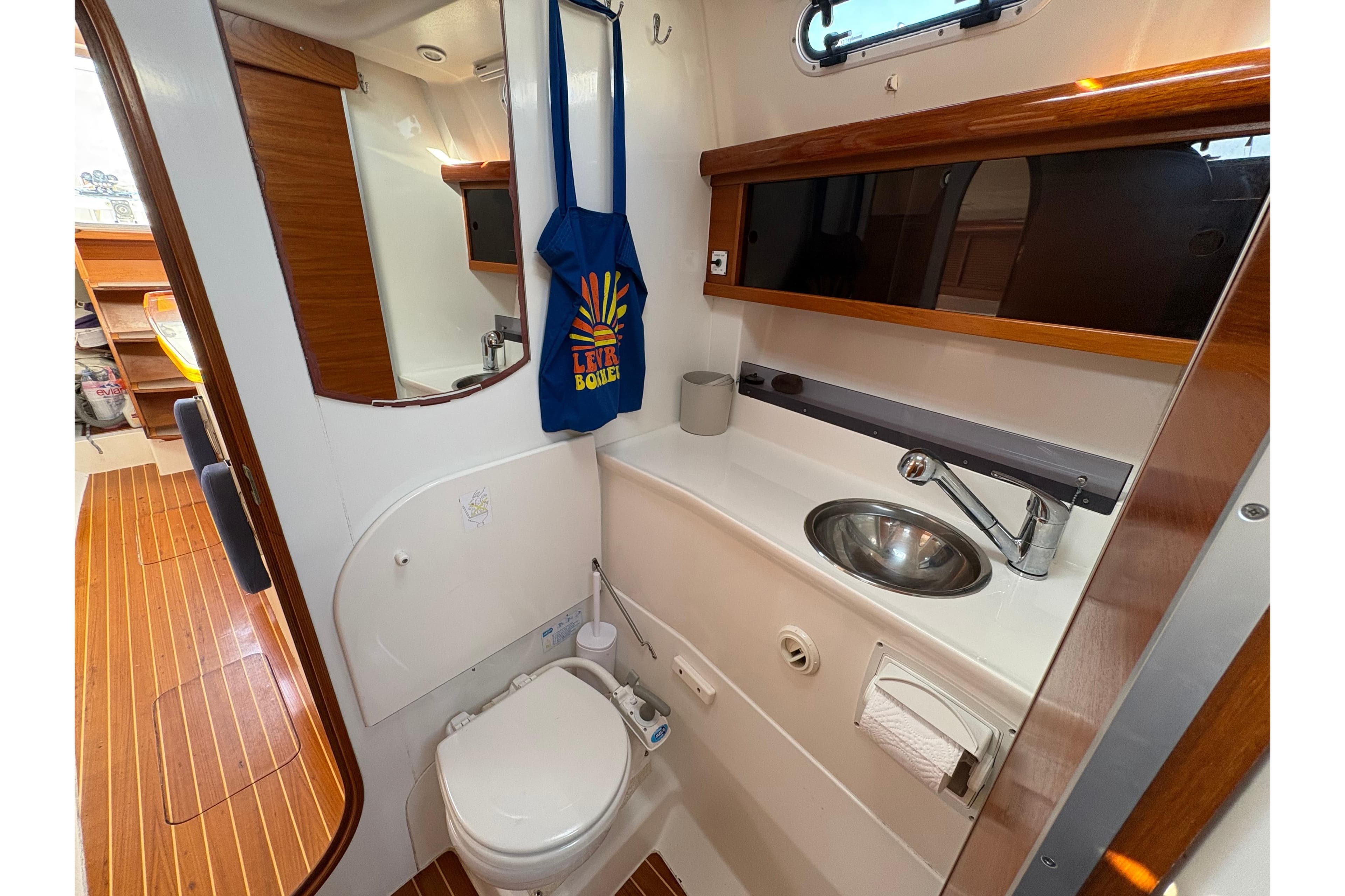 Bathroom interior of 2007 Dragonfly 35 sailboat with wooden accents and compact design.