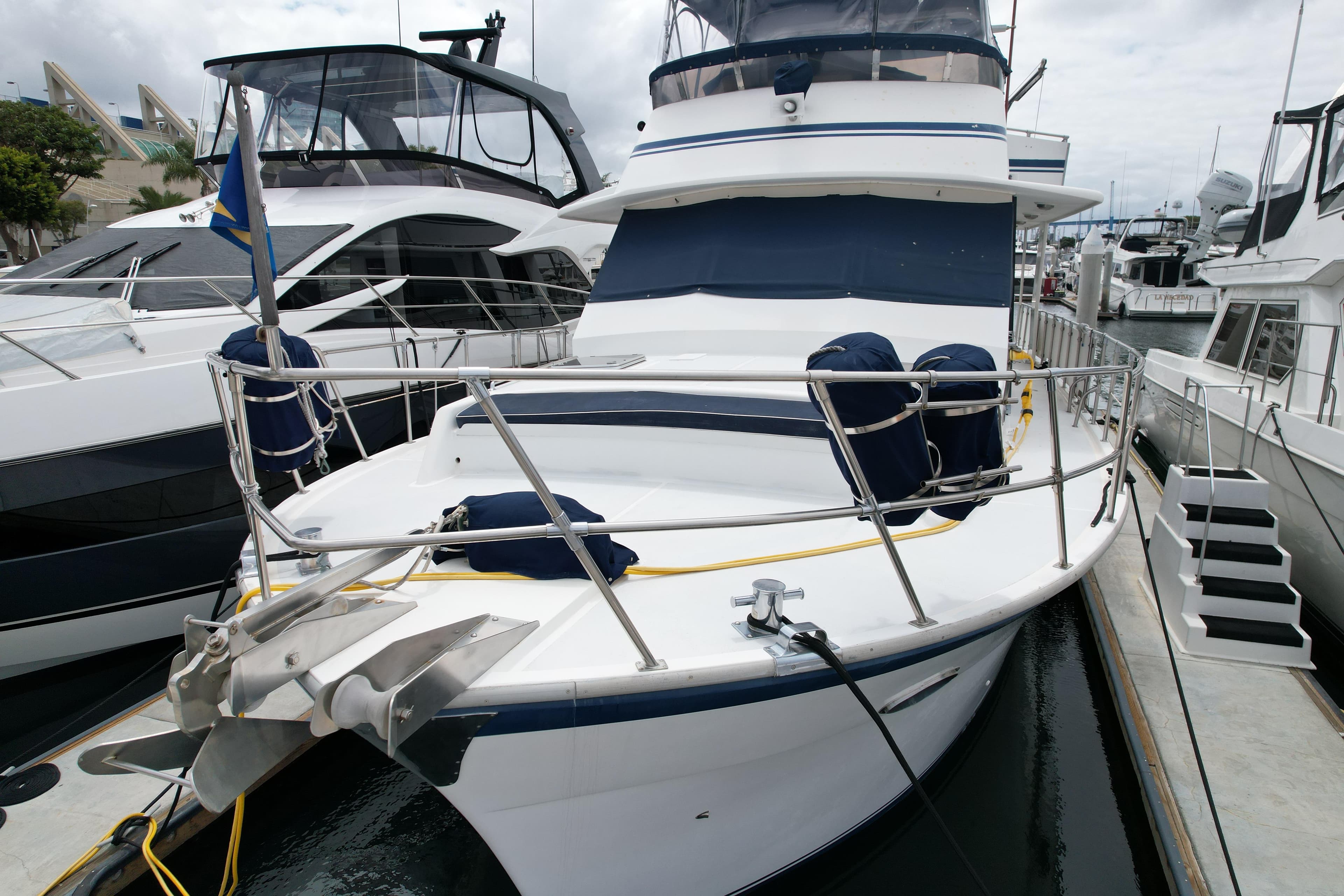 1988 Sea Ranger 51 Motor Yacht docked at marina, featuring spacious deck and sleek design.