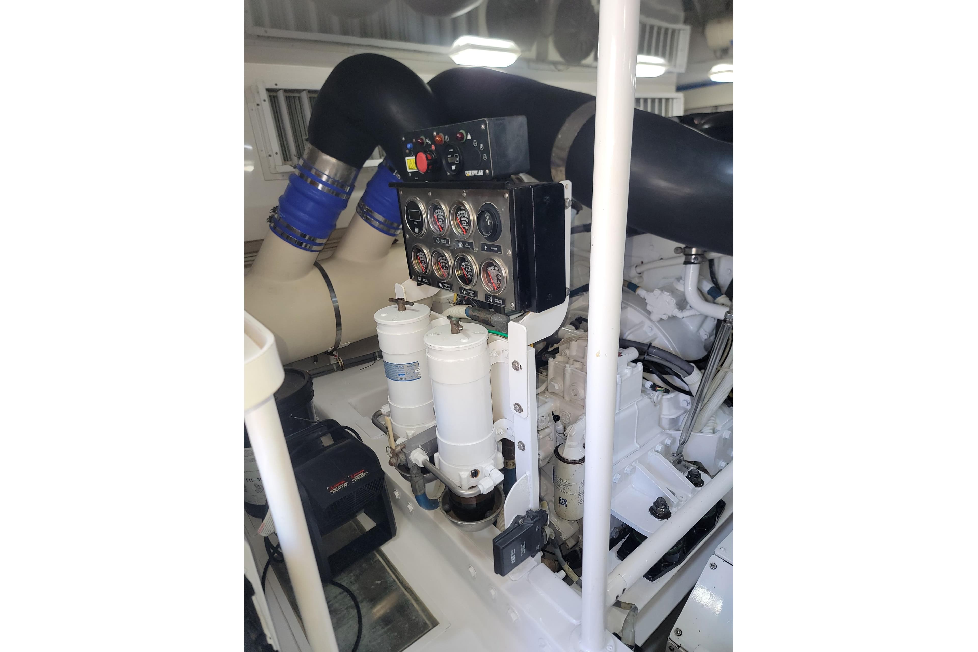 Engine room of a 2012 Viking 64c yacht, featuring gauges and filters.