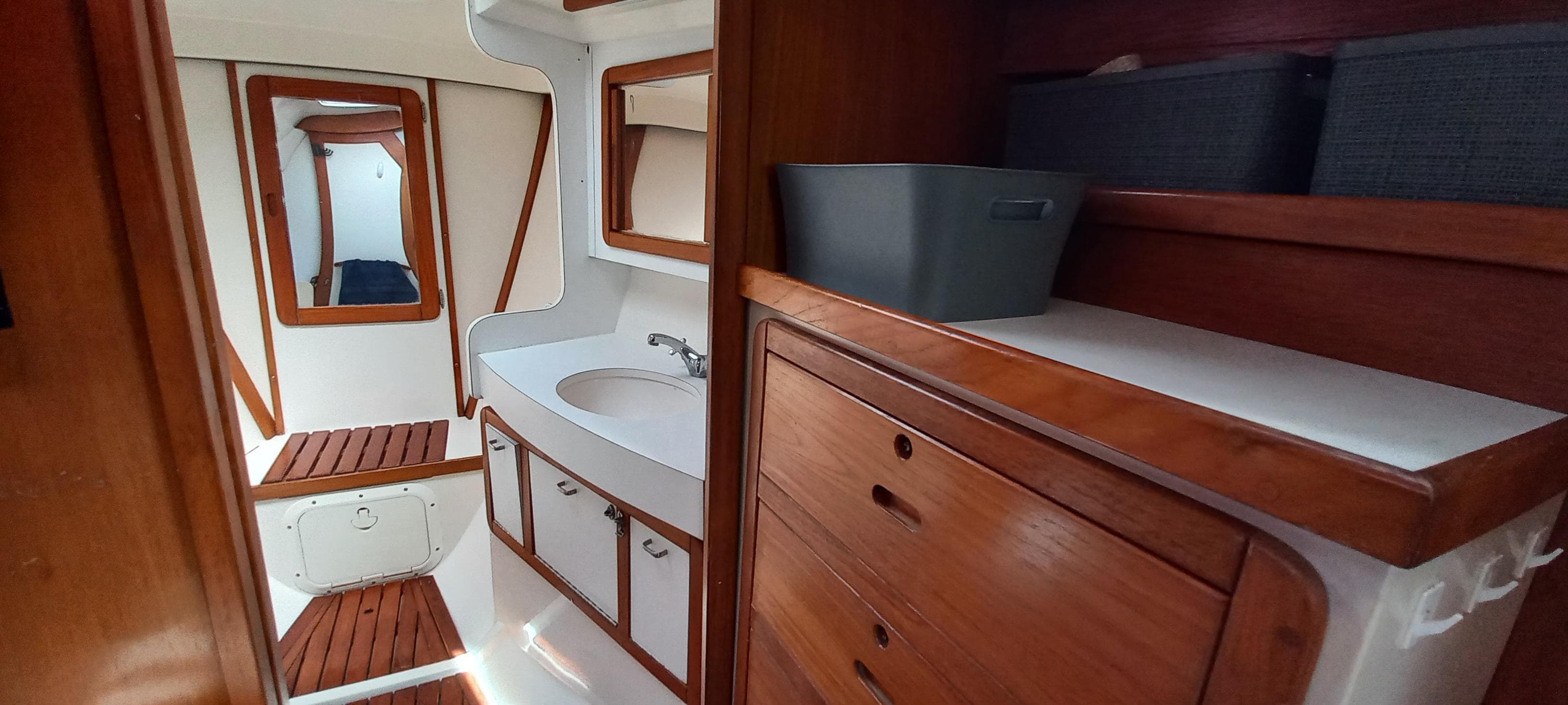 Interior of 1992 Catalina 42 sailboat with wooden cabinetry and compact bathroom.