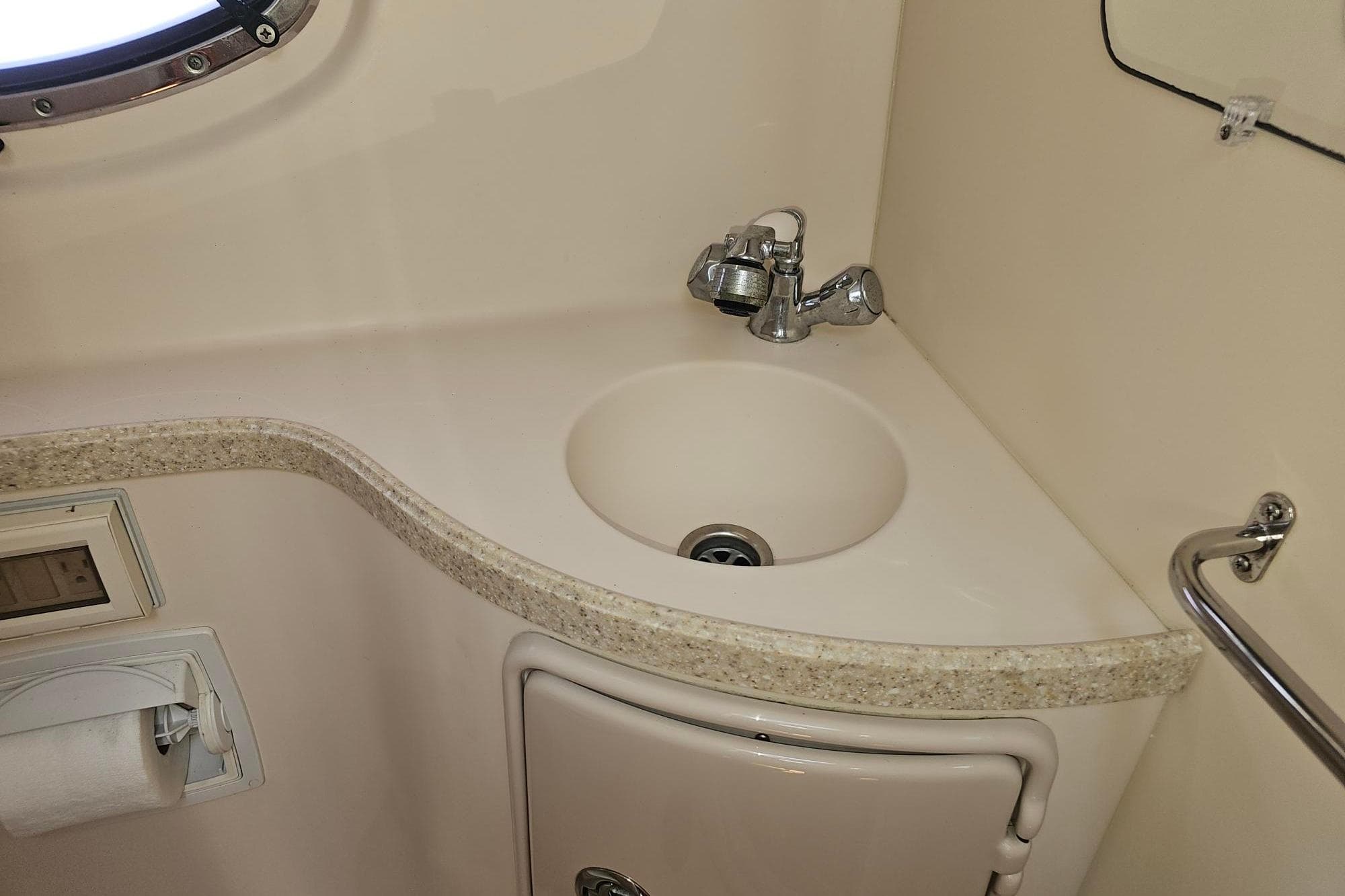 2009 Regal 2860 Window Express bathroom sink with faucet and countertop.