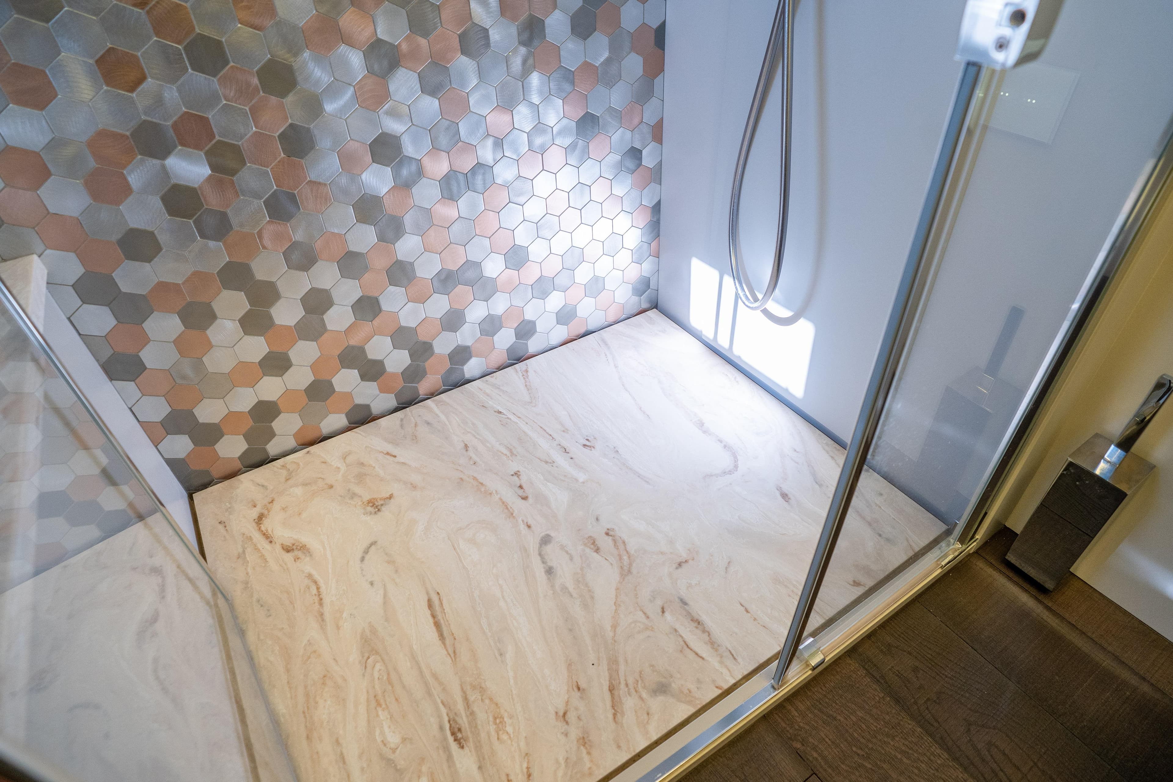 Luxurious shower with hexagonal tiles in 2024 Pershing 7X yacht bathroom.
