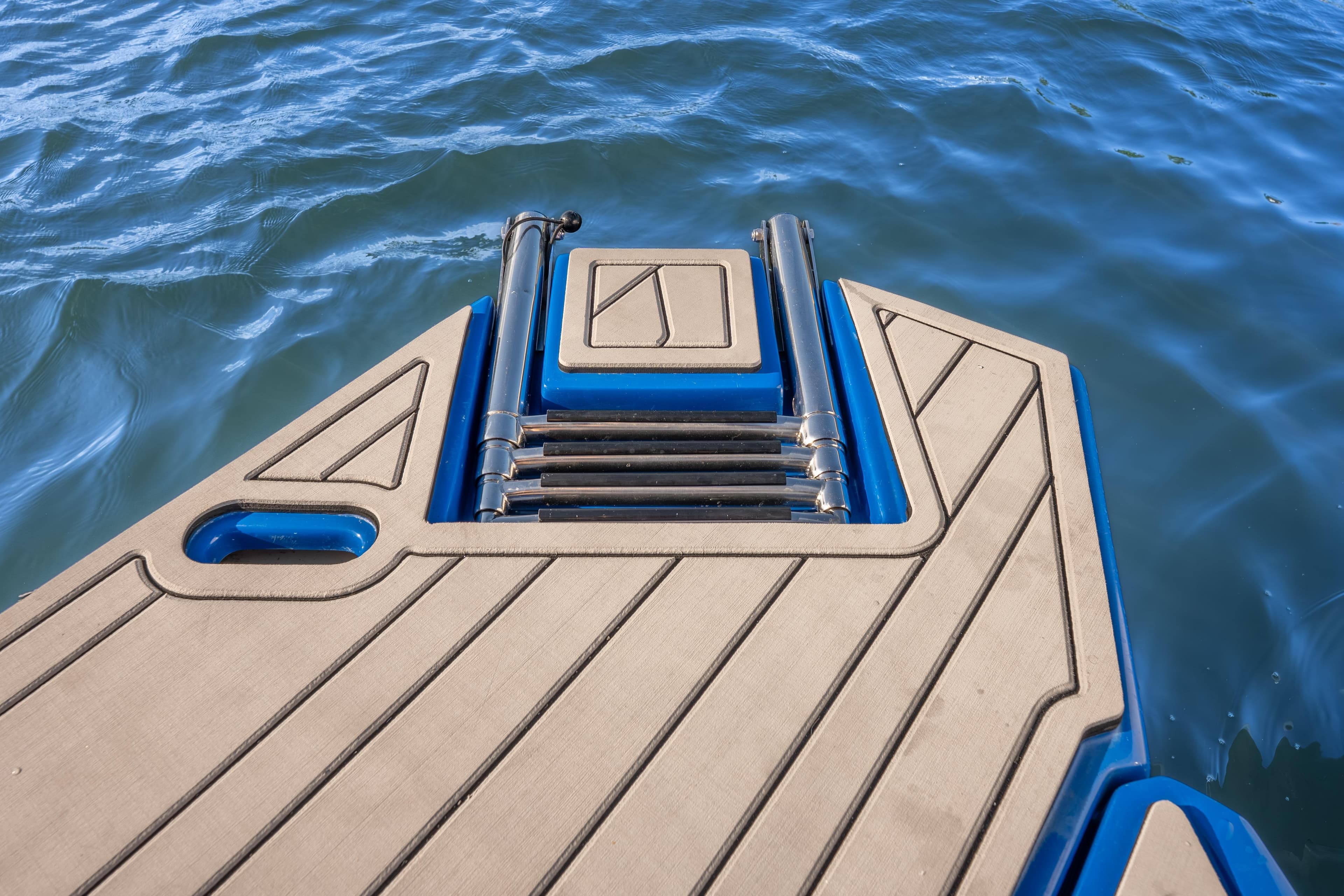 Sleek Hanover 347 boat deck with ladder, 2026 model, on calm blue water.