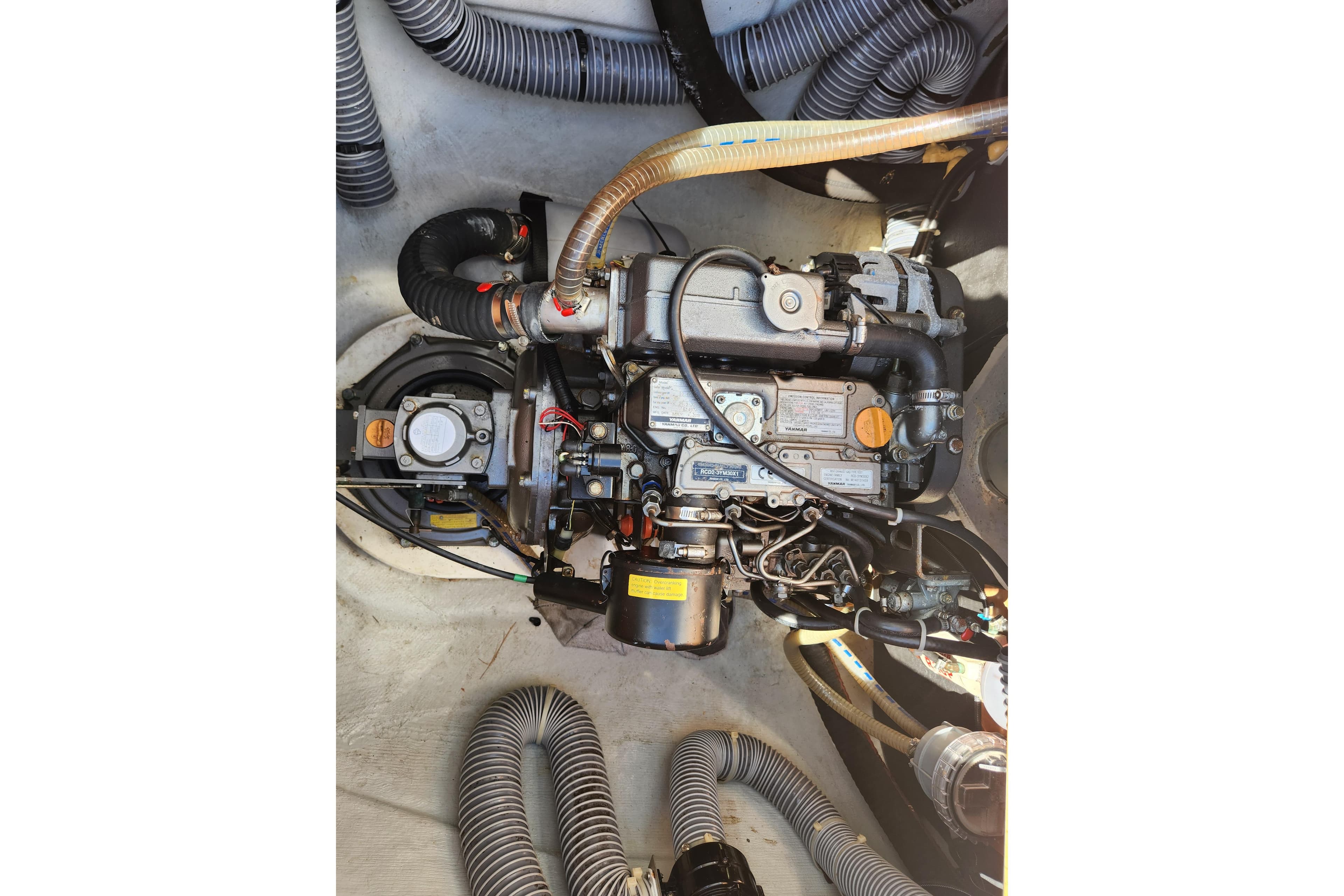 Engine compartment of a 2019 Lagoon 380 catamaran, showcasing detailed mechanical components.