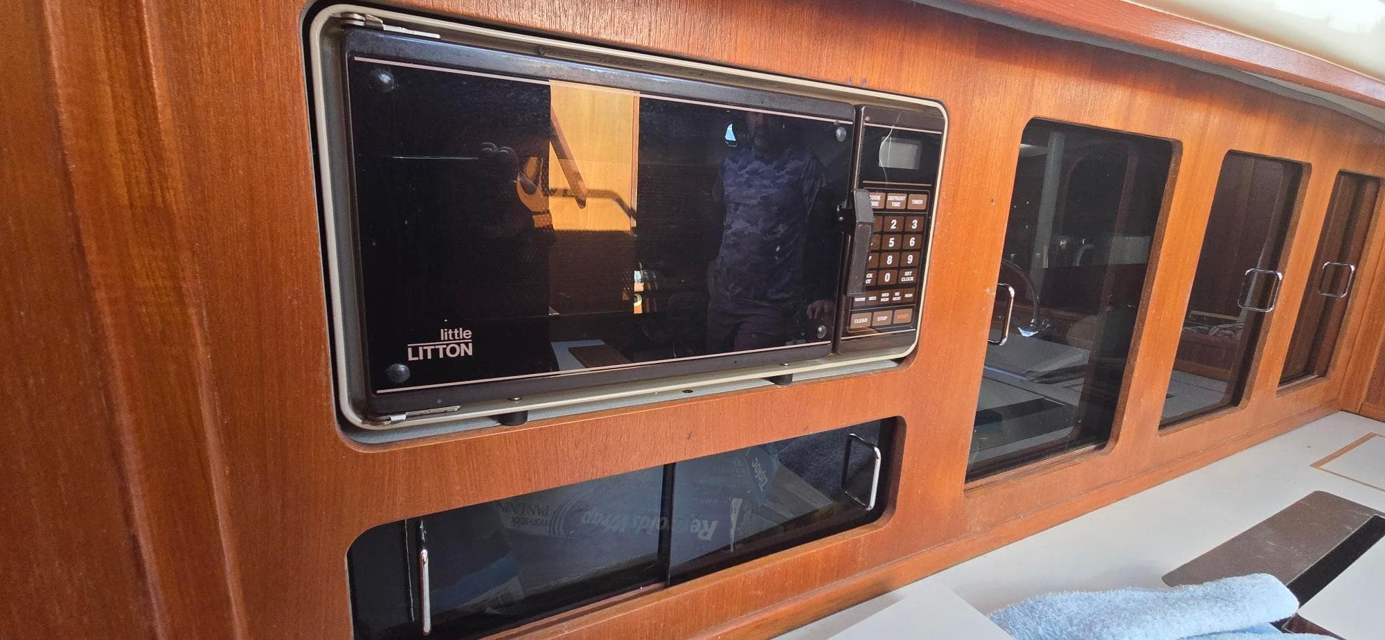 1988 Hunter Legend 37 yacht interior with built-in Litton microwave and wooden cabinetry.