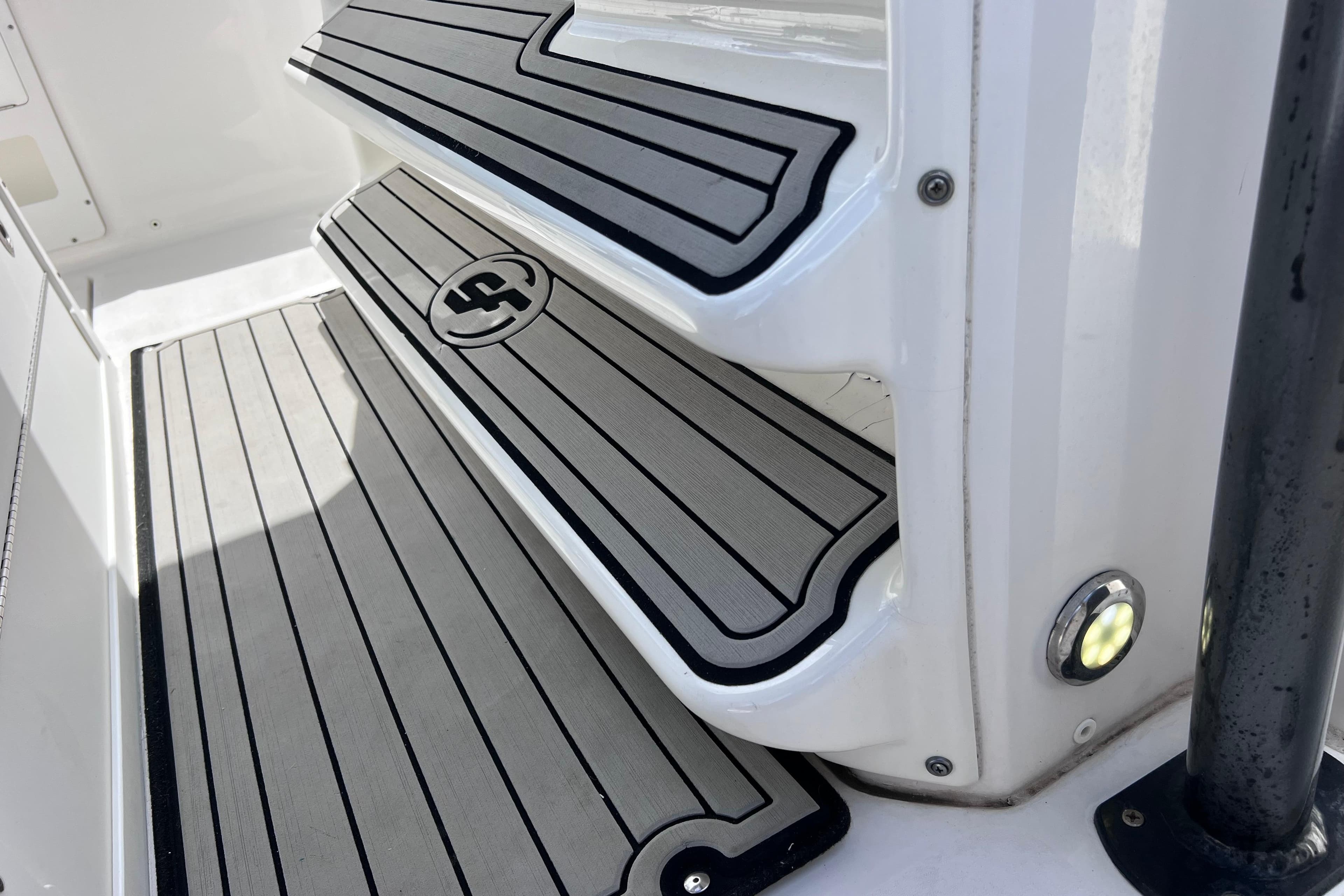 Non-slip steps on a 2019 Sea Fox 328 Commander boat, featuring sleek design and lighting.
