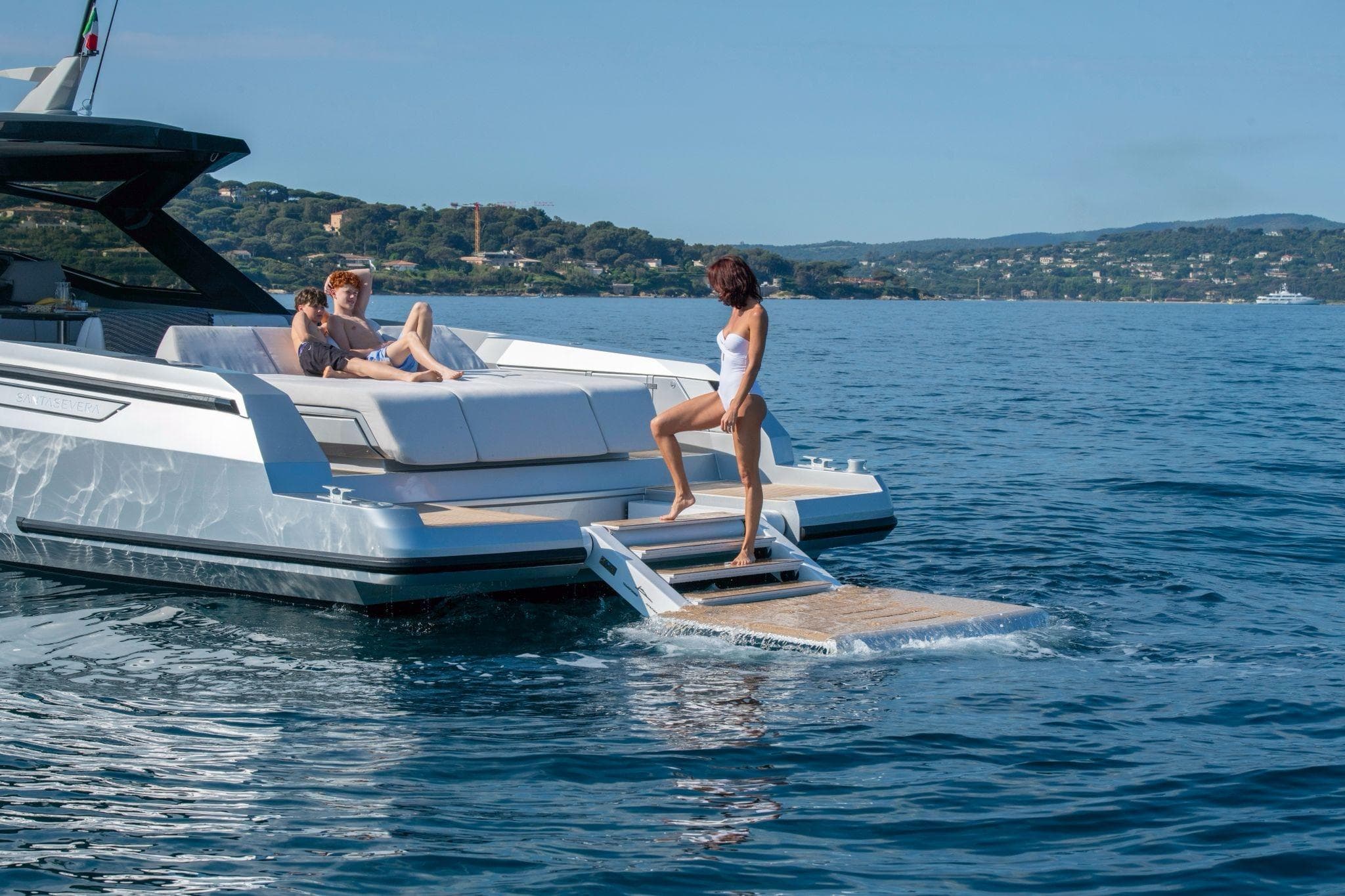 Luxury Santasevera 52 yacht, 2026 model, with people relaxing on deck in scenic waters.