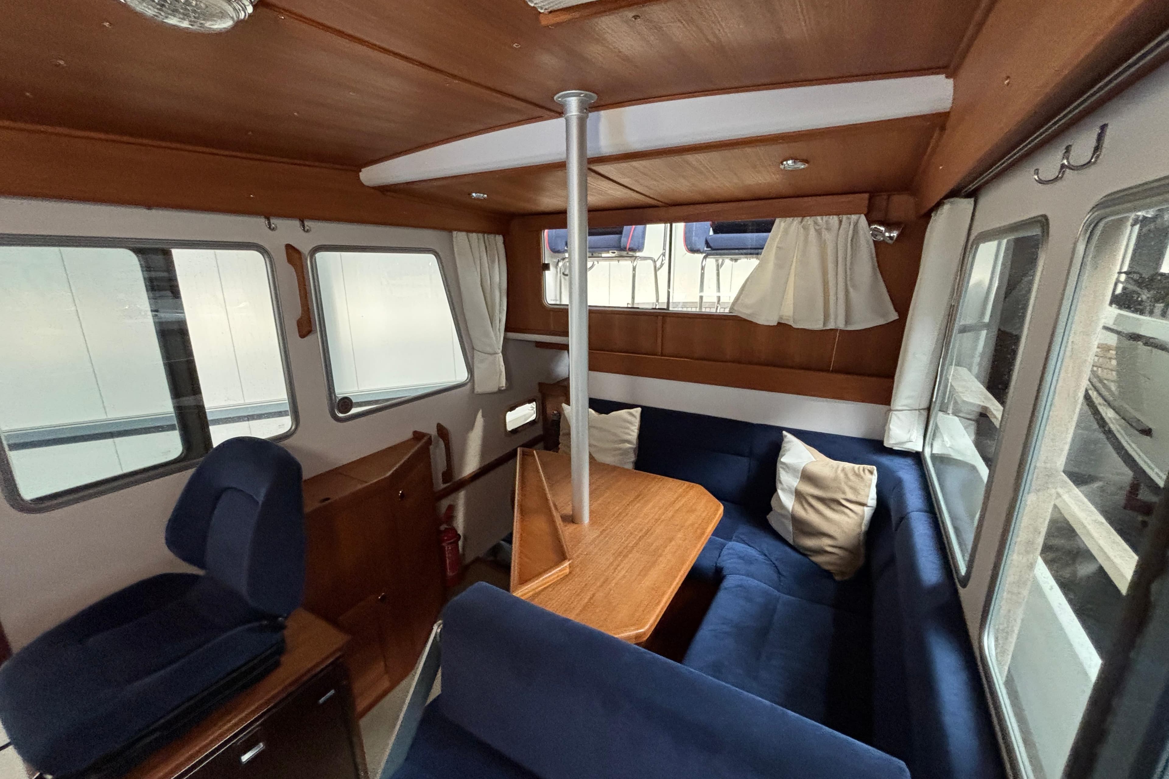 Interior of 2009 Targa 31 boat with cozy seating and wooden table.
