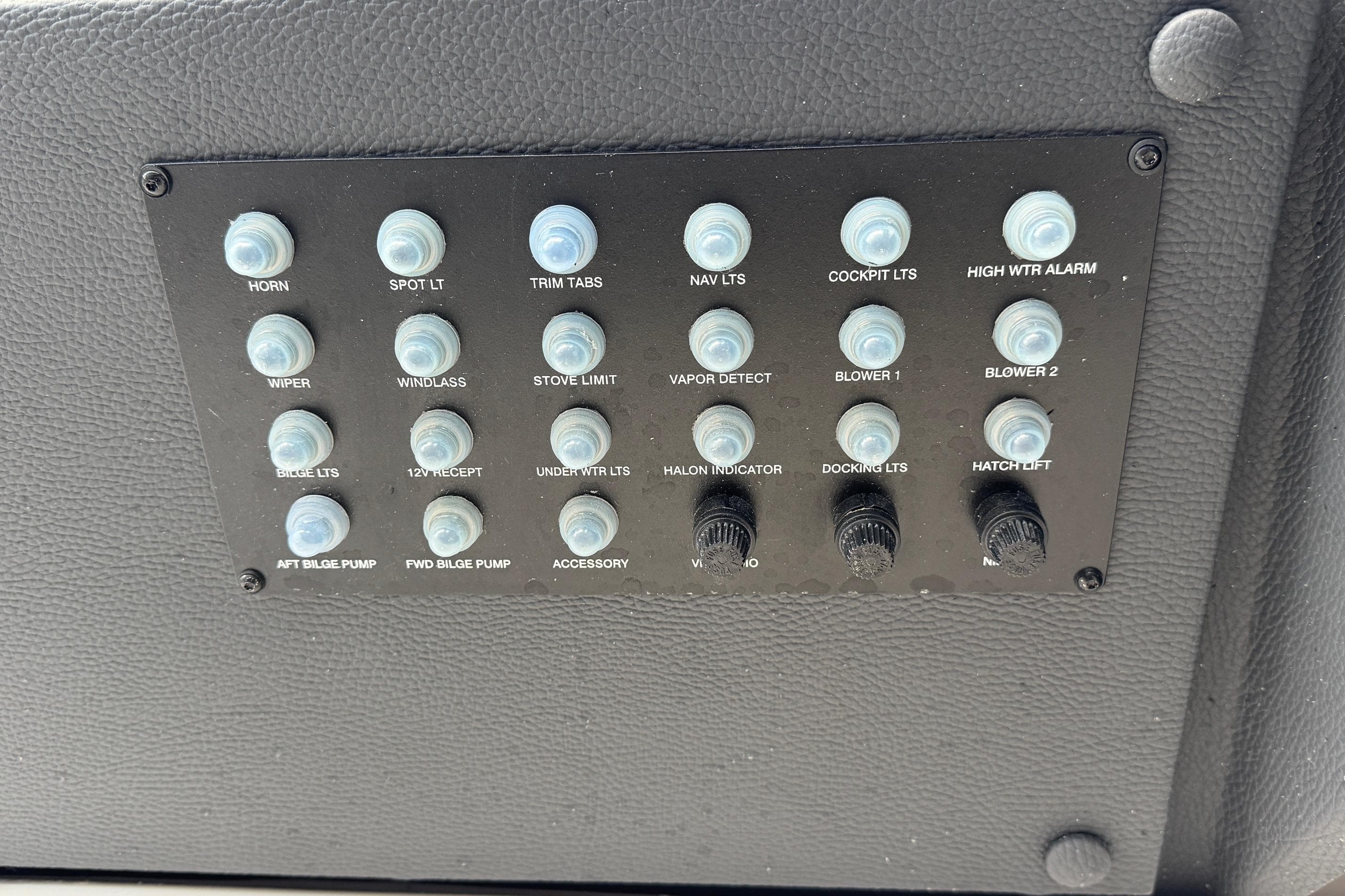 Control panel of a 2026 Regal 33 XO boat with labeled switches and buttons.