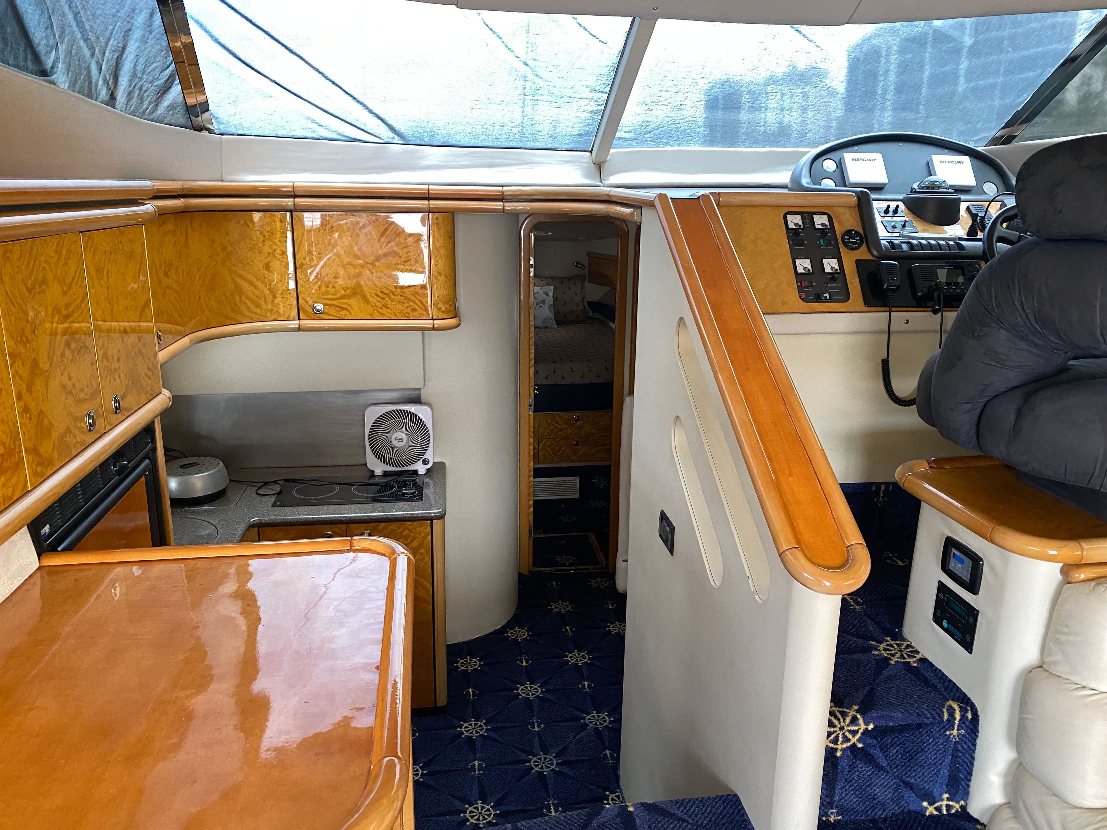 Interior of a 1997 Sunseeker Manhattan yacht with wooden cabinetry.