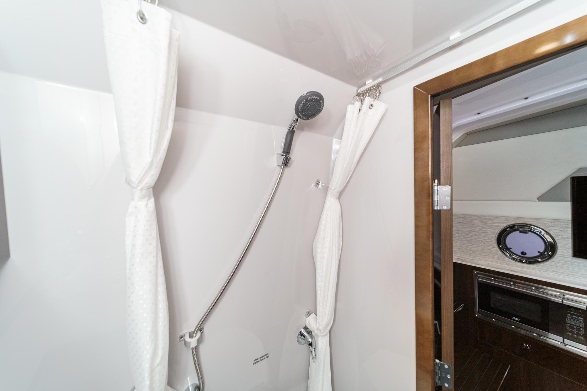 2022 Cruisers 42 GLS yacht bathroom with shower and modern interior design.