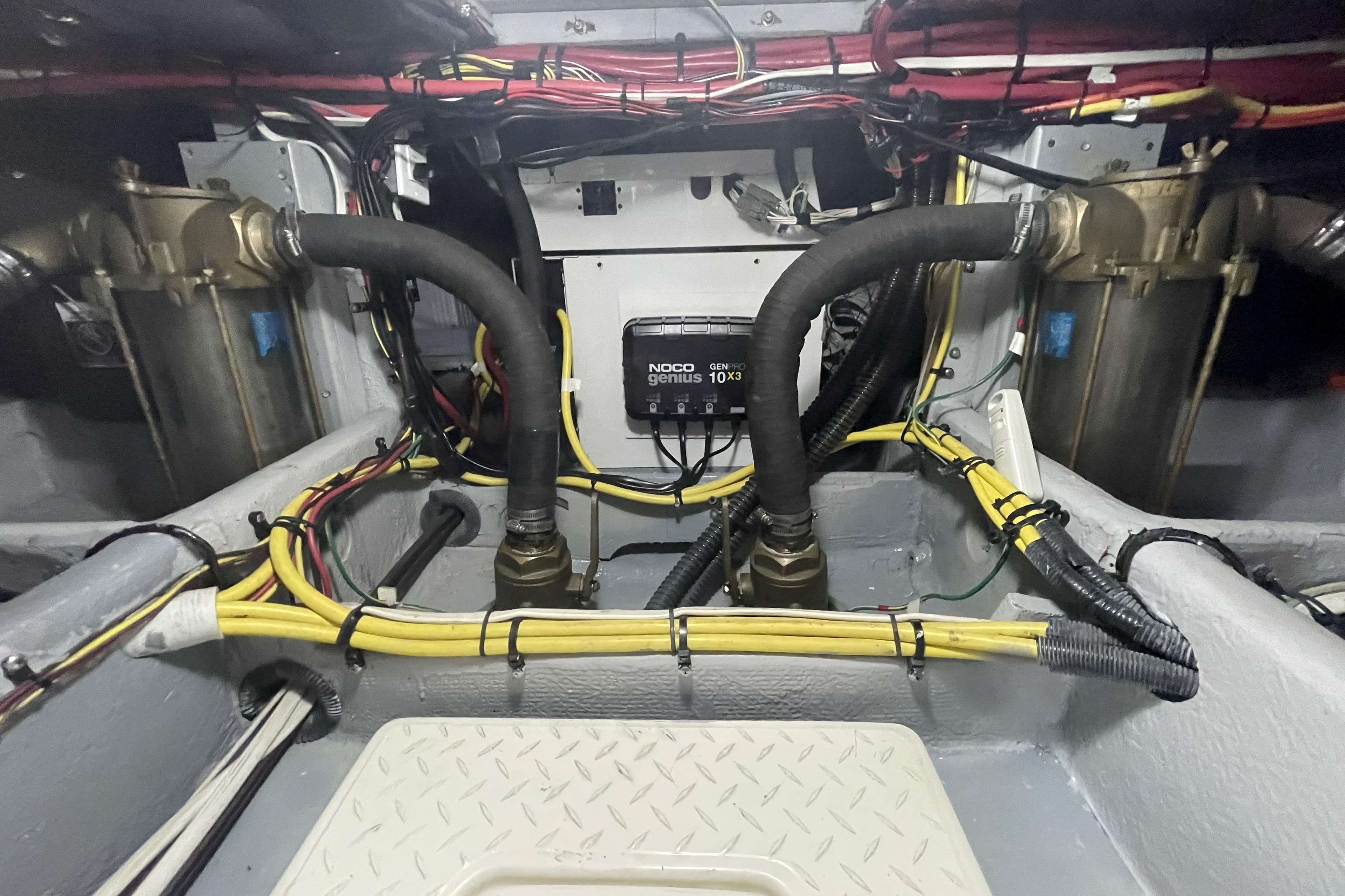 Engine room of a 2008 Meridian 490 Pilothouse with wiring and hoses visible.
