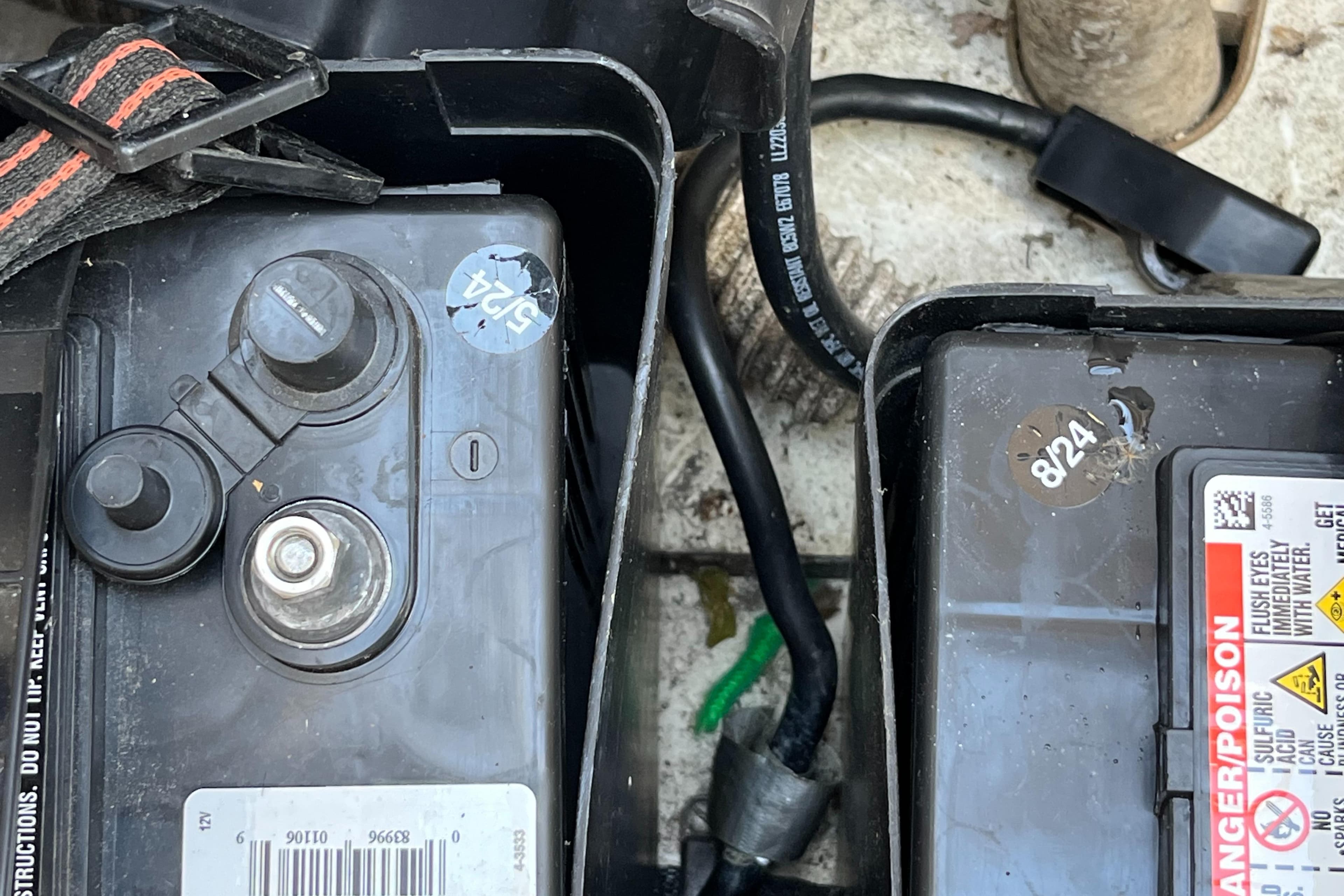 Battery compartment of a 1992 Hunter 30-2 sailboat with visible wiring and labels.
