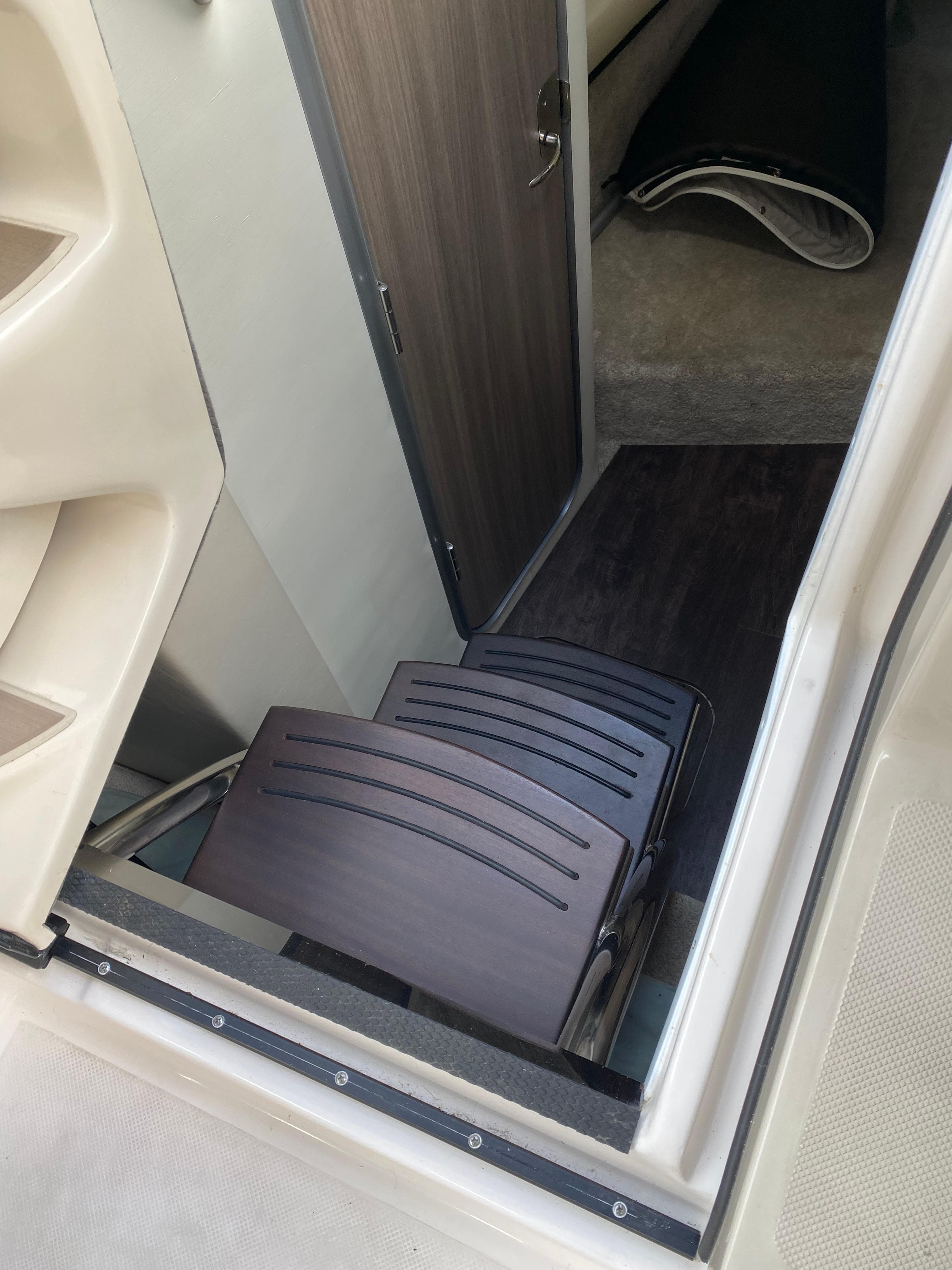 2022 Regal 26 XO cabin entrance with wooden steps and interior view.