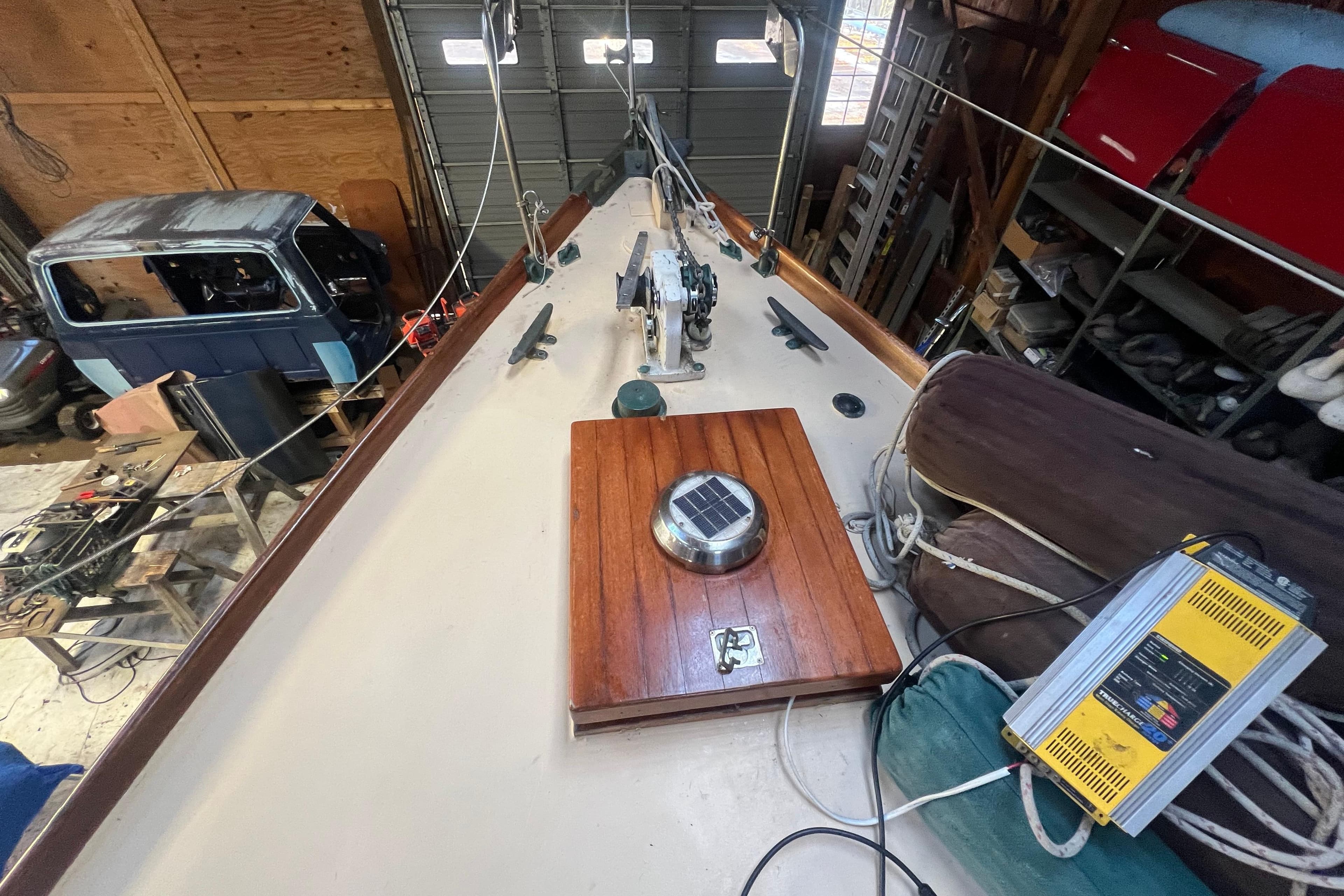 1962 Ted Hood Little Harbor 40 Yawl in a workshop, showcasing deck details and equipment.