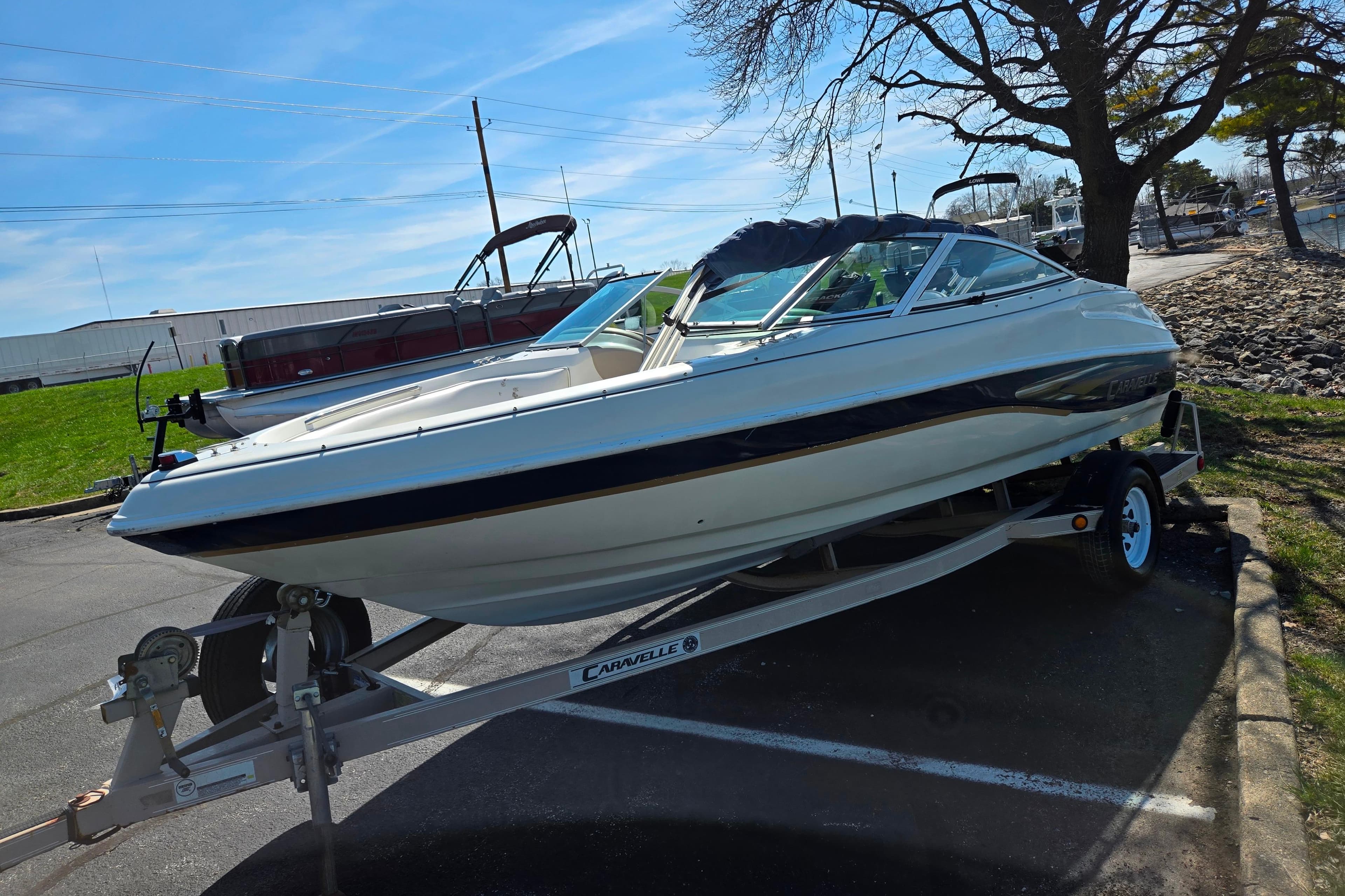 2001 Caravelle 188 Bow Rider boat on trailer in parking lot.