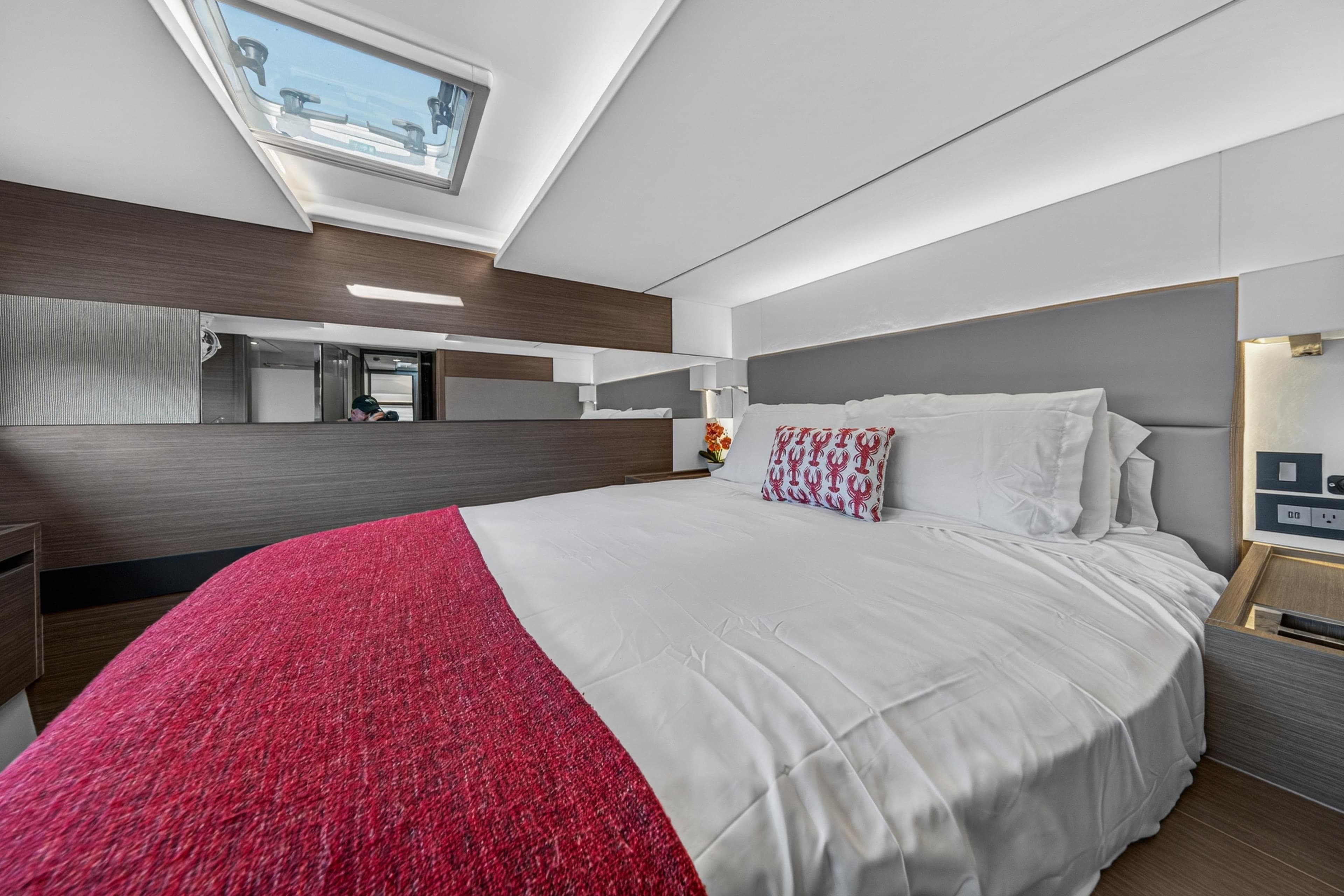 Luxurious bedroom interior of 2022 Leopard 53 Powercat yacht with skylight and modern design.