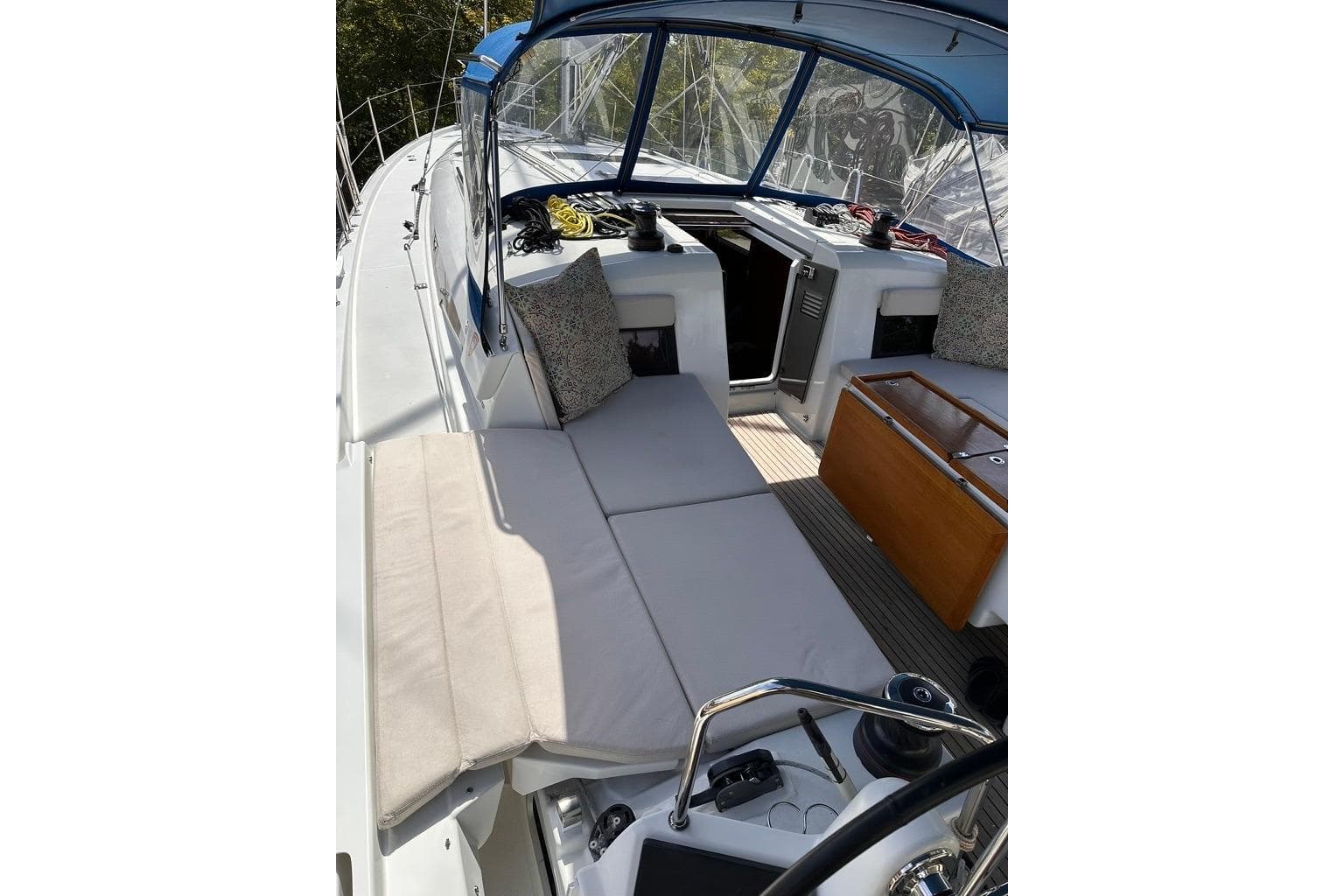2019 Jeanneau Sun Odyssey 490 sailboat cockpit with cushioned seating and helm.
