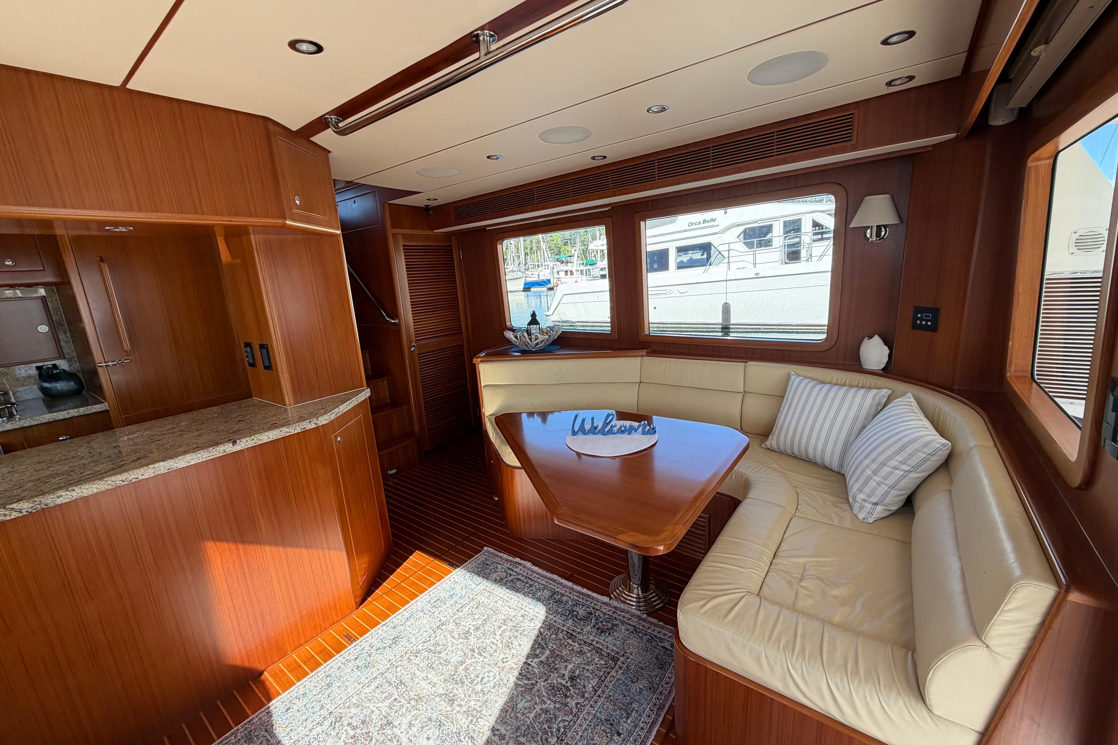Luxurious 2016 Nordhavn 52 yacht interior with elegant wood finishes and cozy seating area.