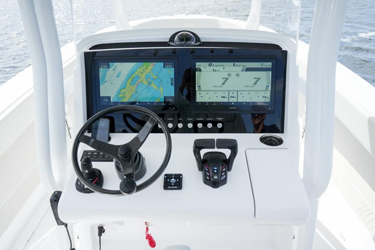 Control panel of 2026 Jupiter 30 boat with navigation screens and steering wheel.