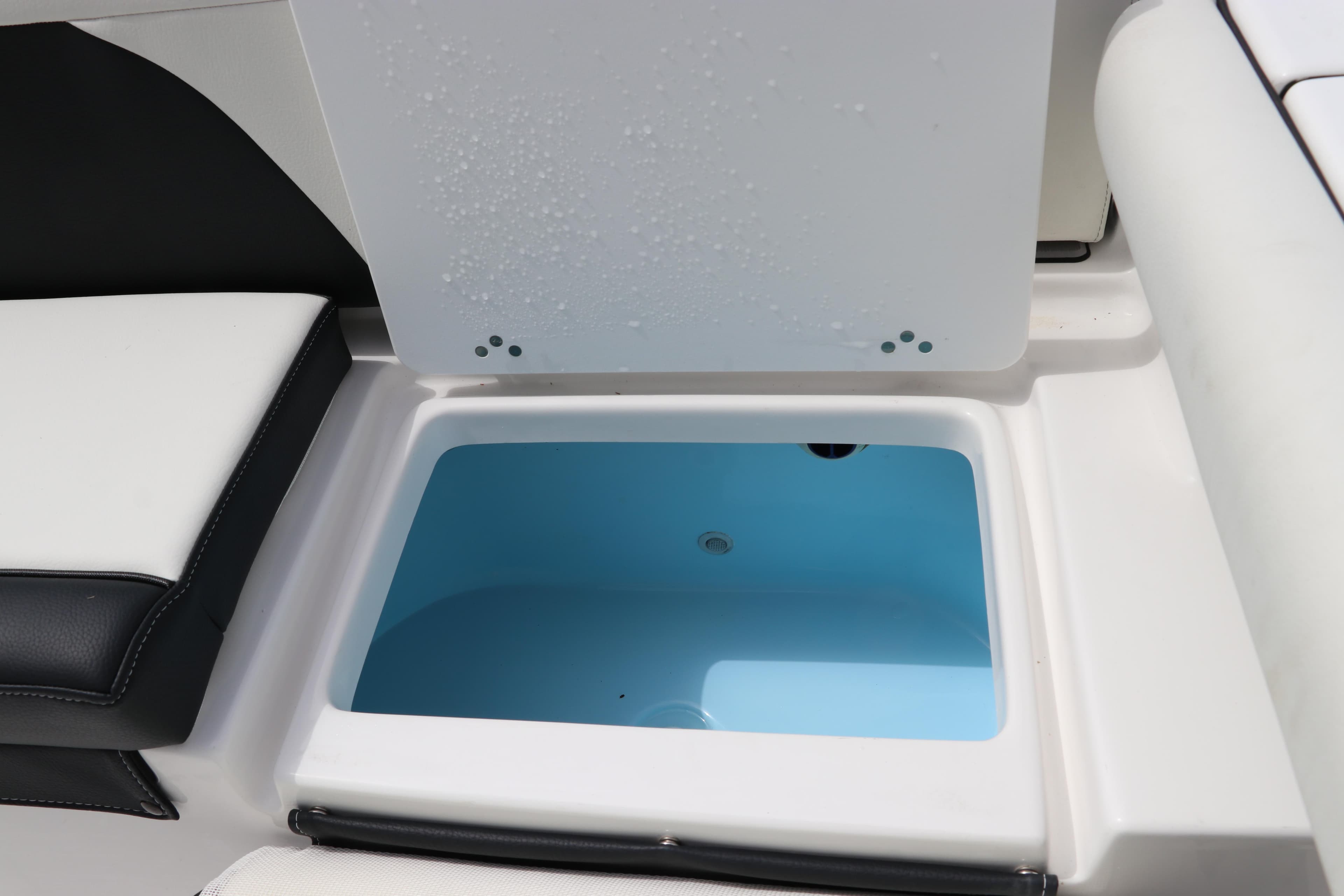 2024 Tidewater 256 LXF boat storage compartment with open lid, showcasing interior space.