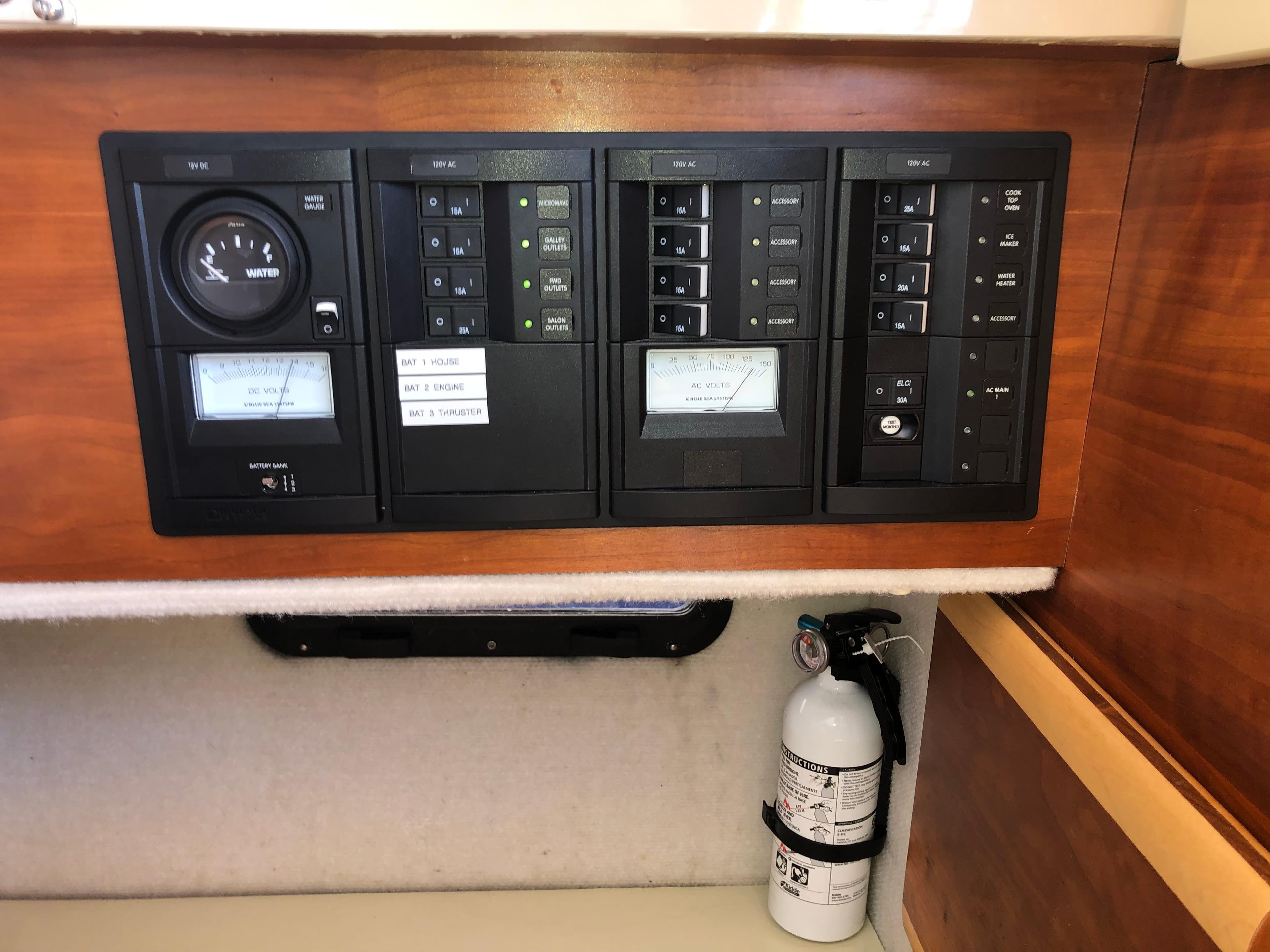 Control panel of a 2016 Cutwater 30 Command Bridge boat with fire extinguisher.