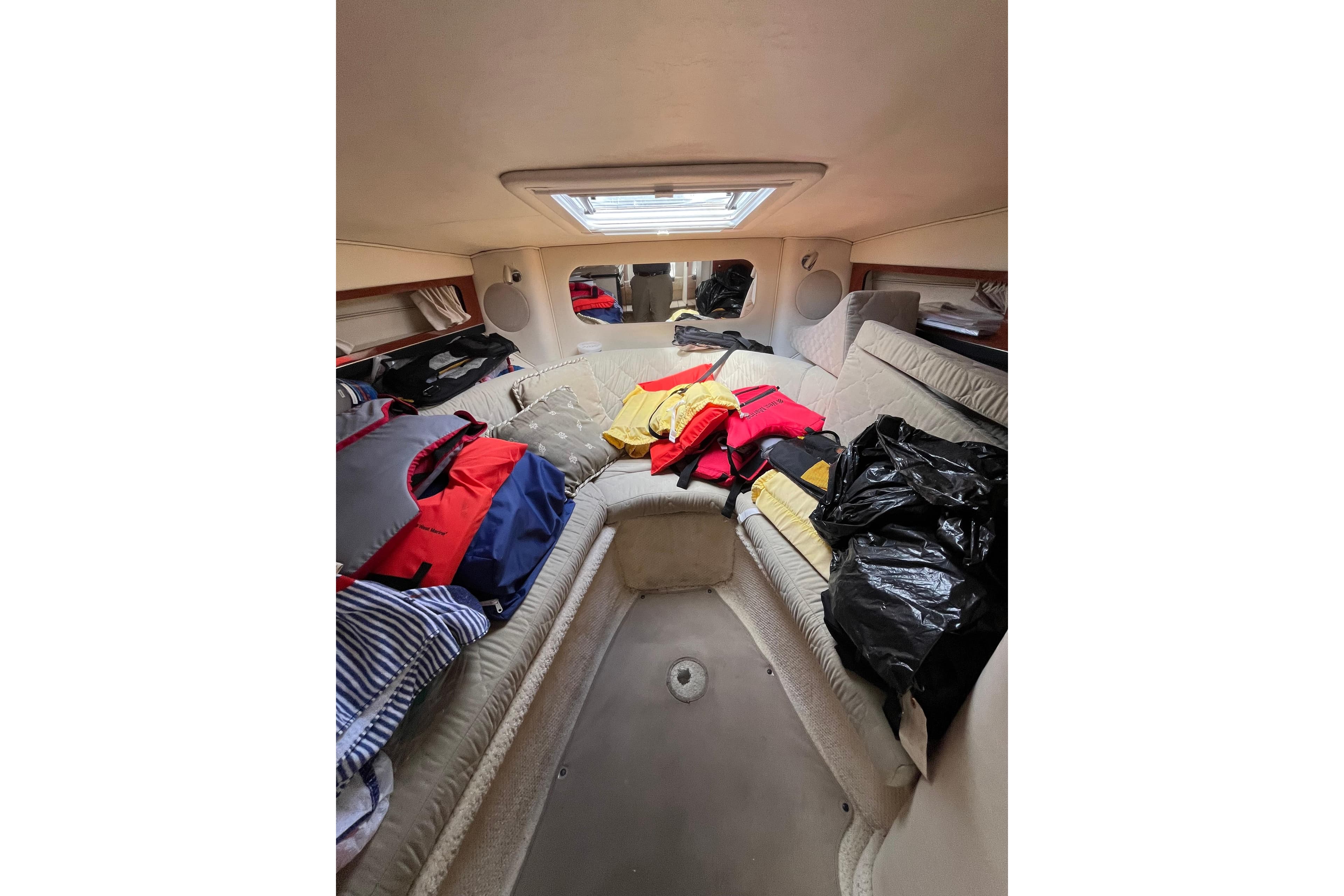 Interior cabin of 2003 Sea Ray 290 Sun Sport with life jackets and seating.