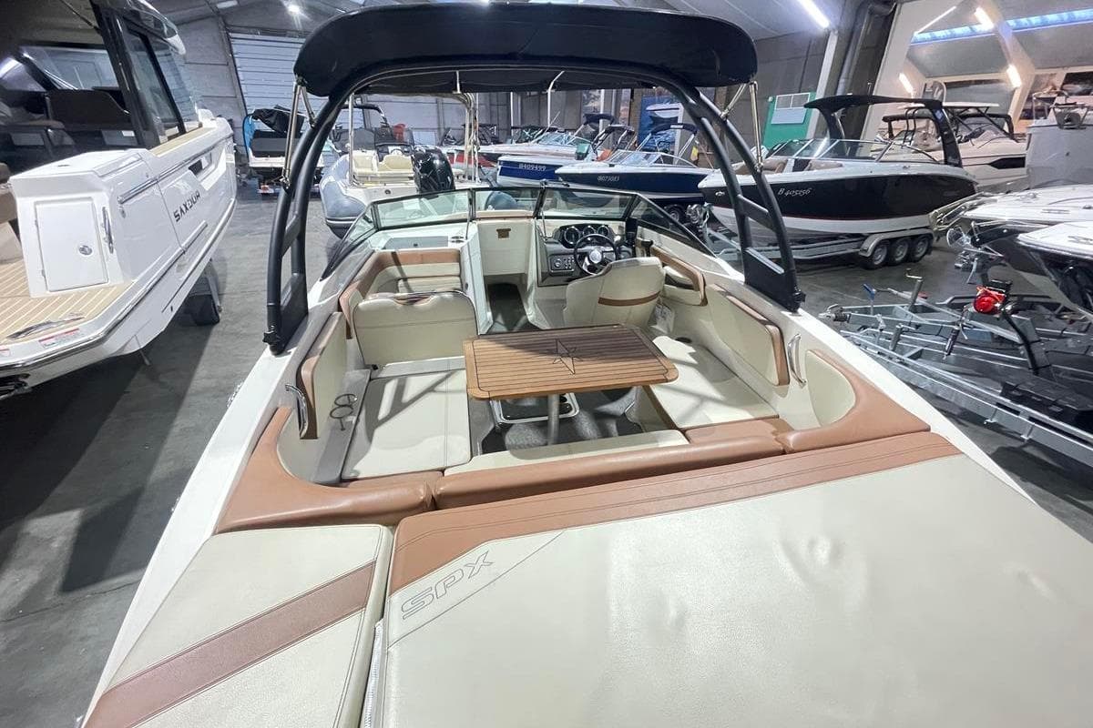 Interior view of a 2017 Sea Ray SPX 210 boat in showroom.
