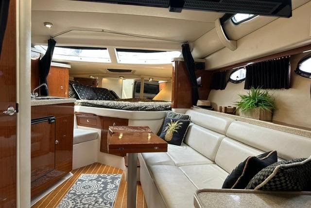 Luxurious interior of a 2005 Regal 3360 Window Express yacht with elegant seating and decor.