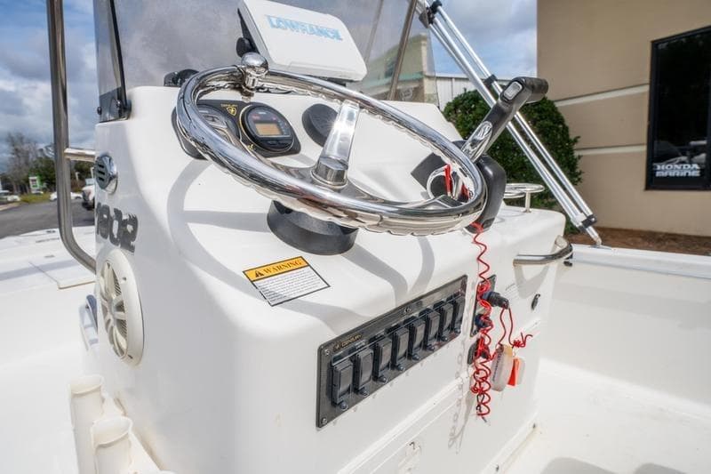 2005 Century 1902 Inshore boat console with steering wheel and controls.