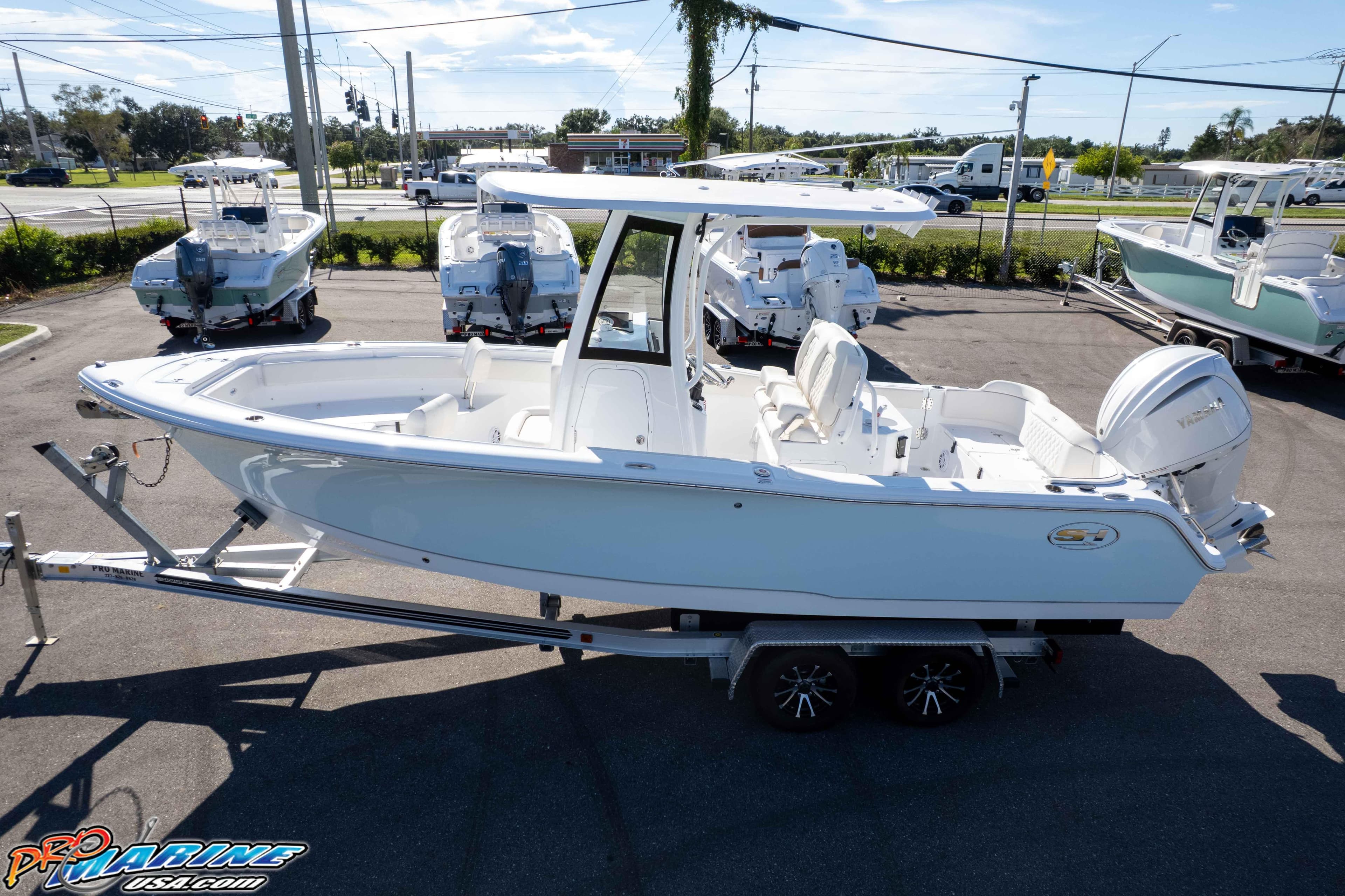 2025 Sea Hunt Ultra 245 SE boat on trailer in parking lot.