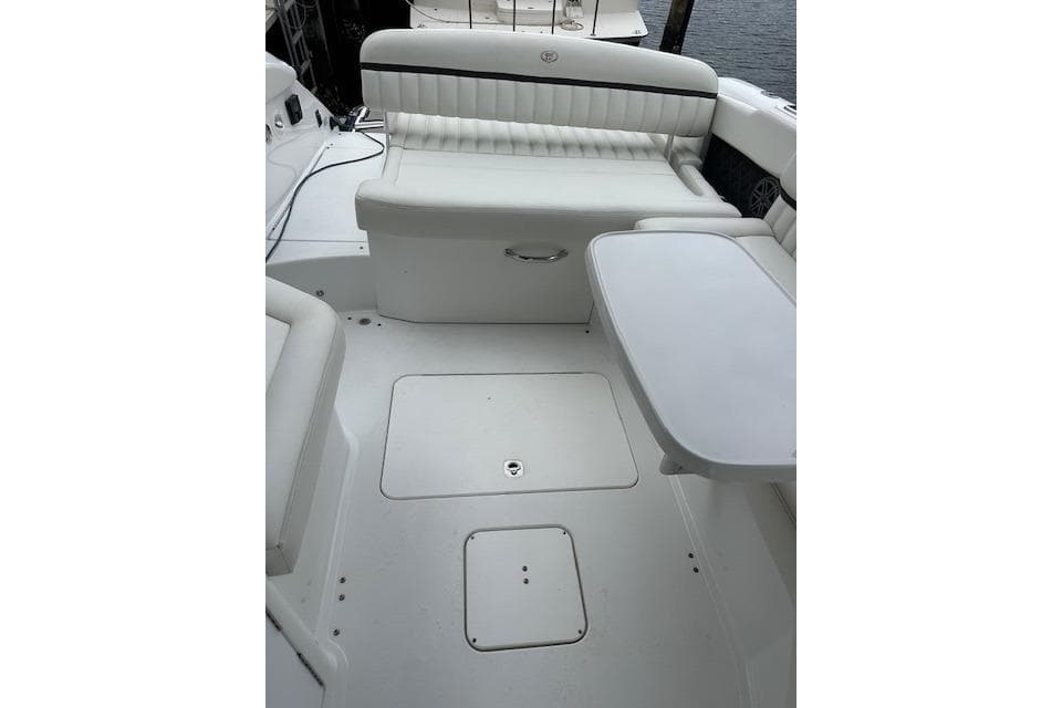 2016 Cobalt A28 boat interior with white seating and table.