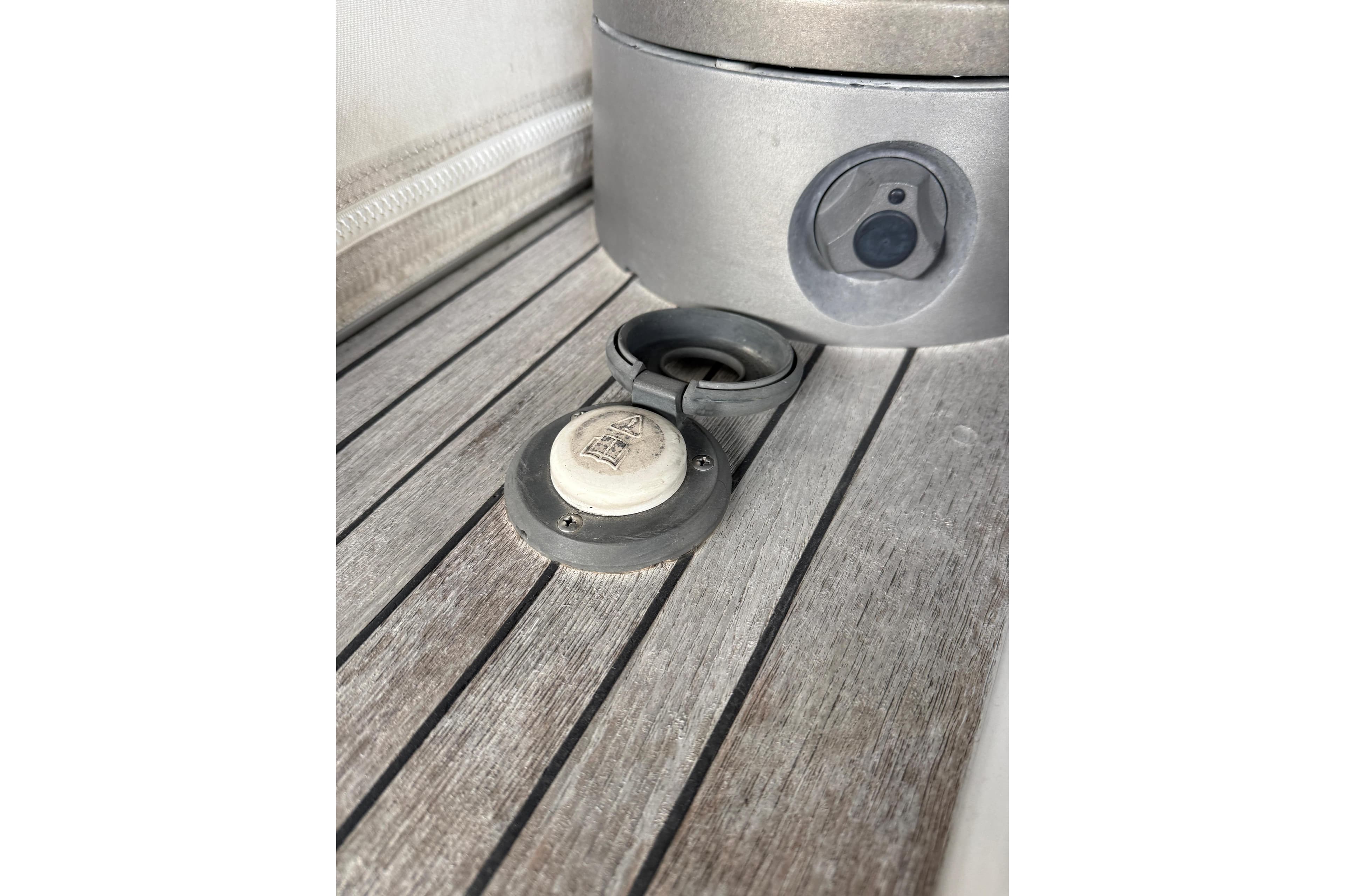 Deck detail of 1997 Nautor Swan 56R yacht, featuring a metal fitting on wooden surface.