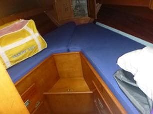 Interior of a 1968 Hinckley Pilot 35 yacht with blue cushions.