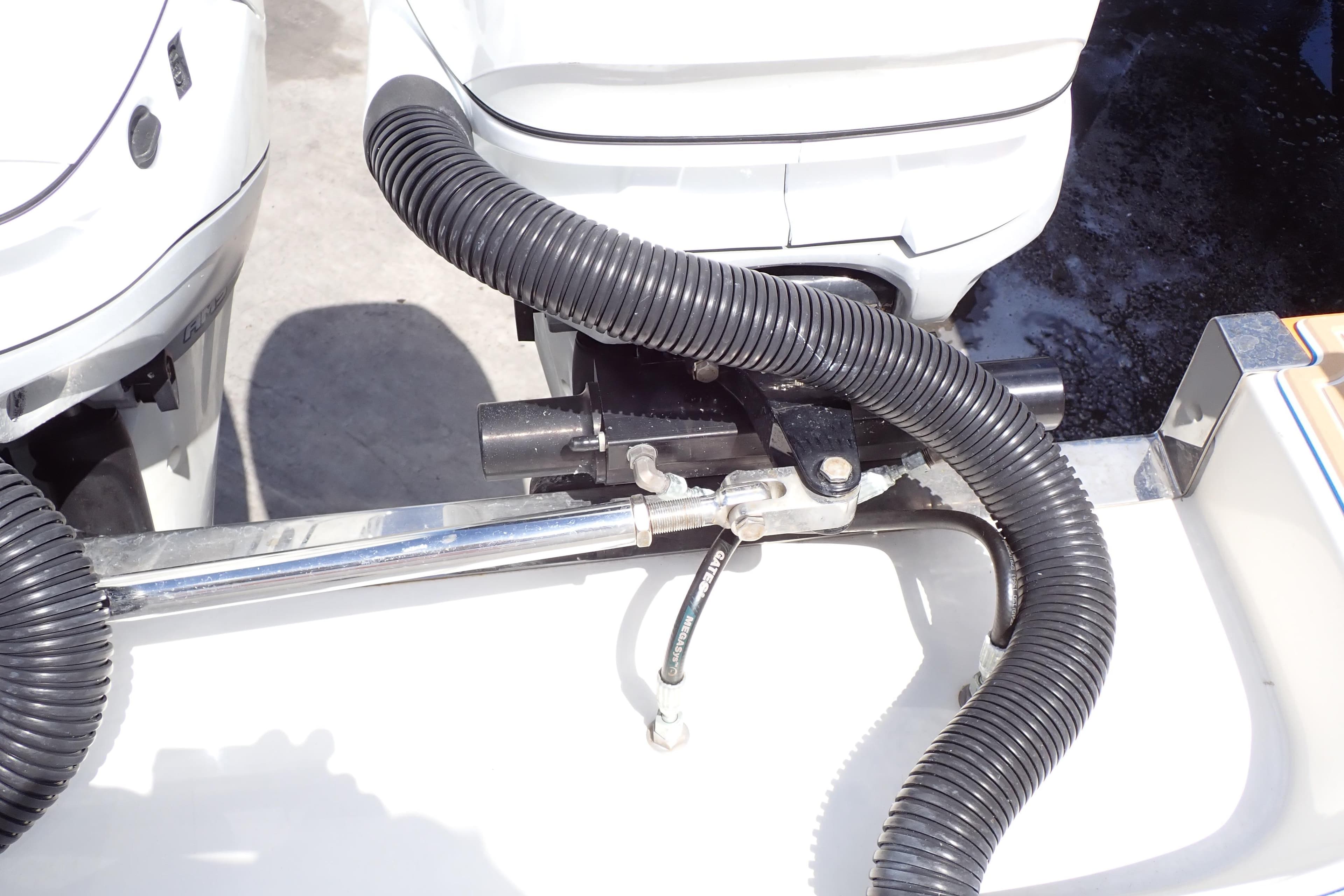 Close-up of 2022 Deep Impact 369 Sport boat engine components and hoses.