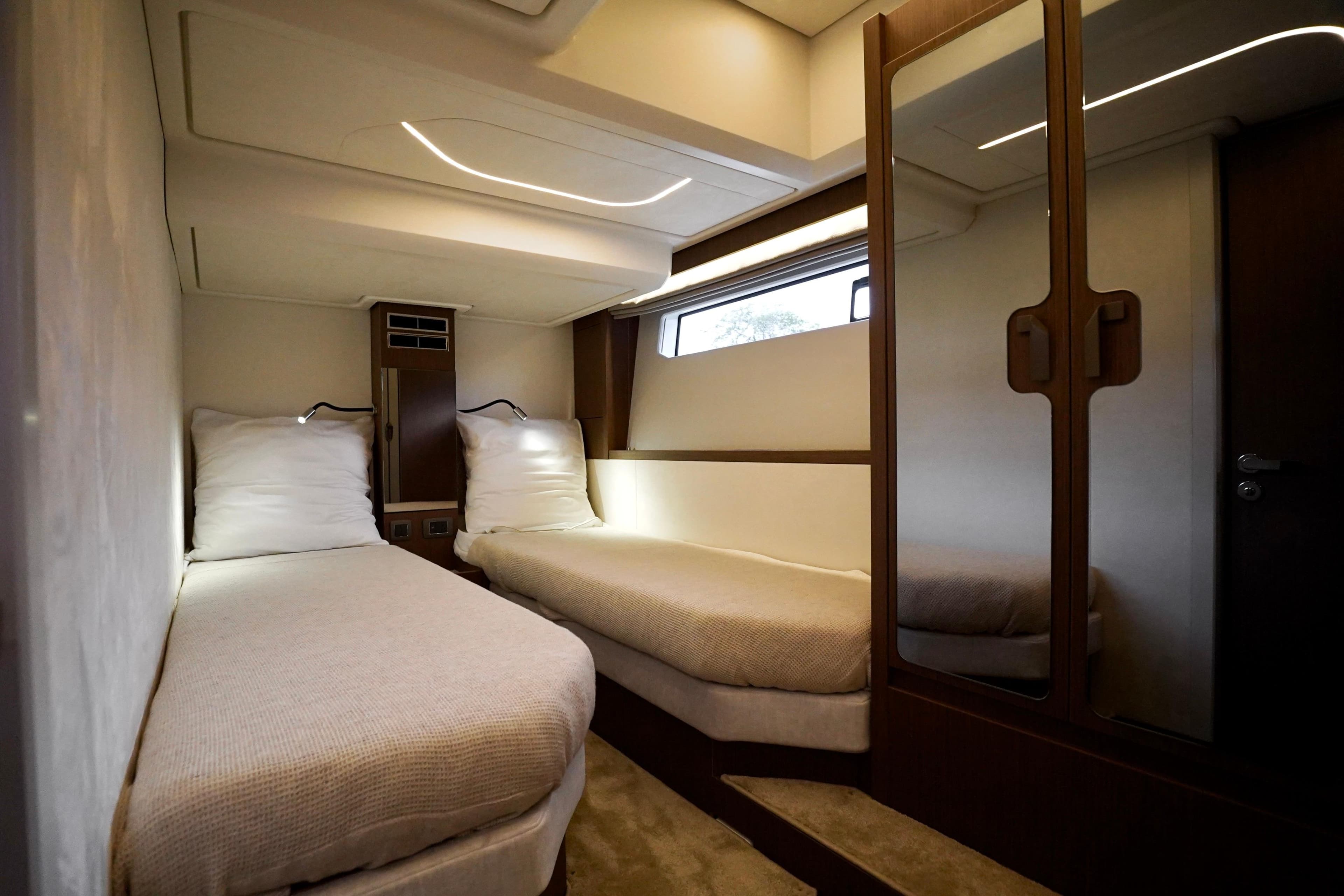 Luxurious twin cabin interior of 2026 Prestige F4.9 yacht, featuring modern design and ambient lighting.