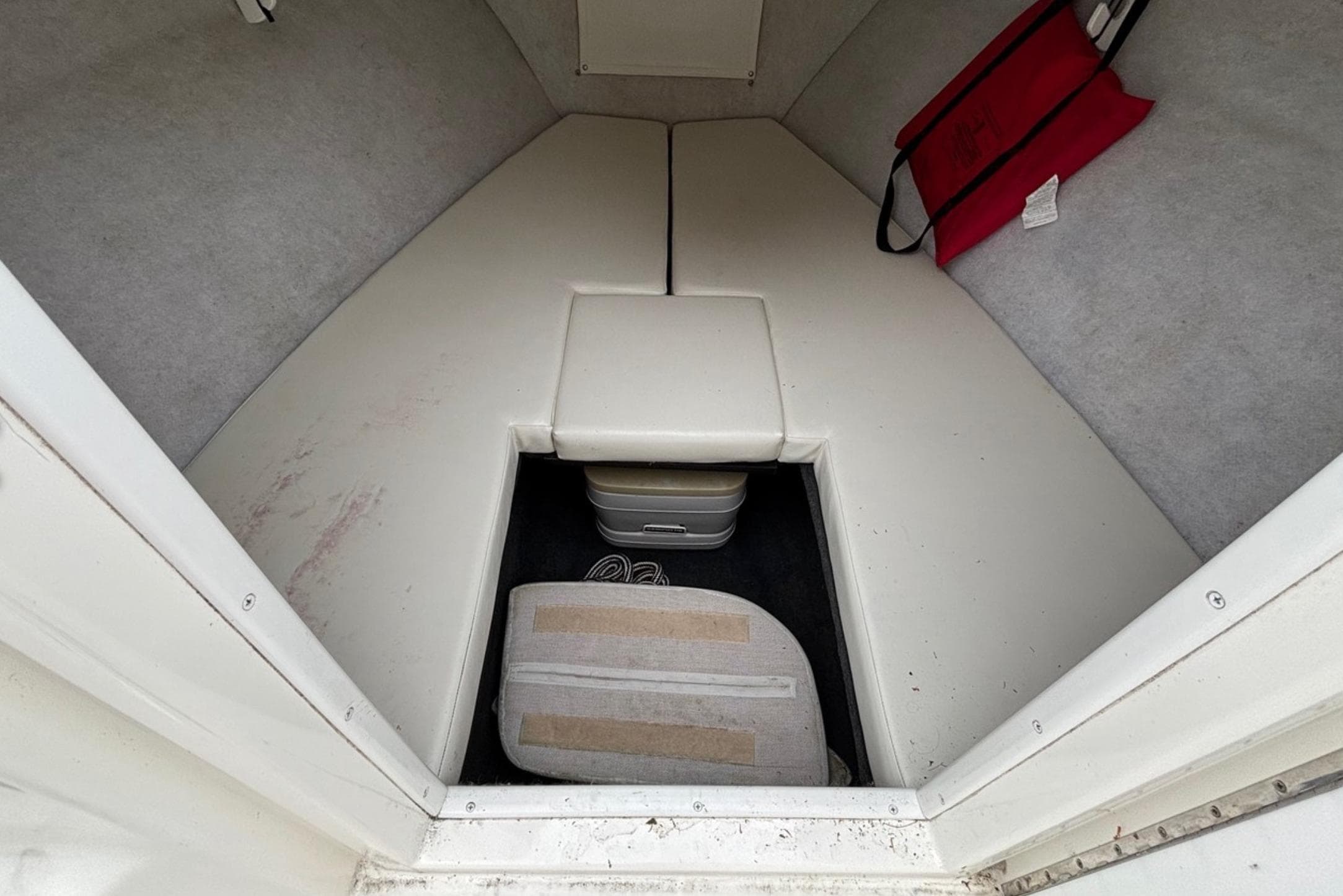 Interior cabin of 1999 Wellcraft 302 Scarab Sport boat with storage and seating.