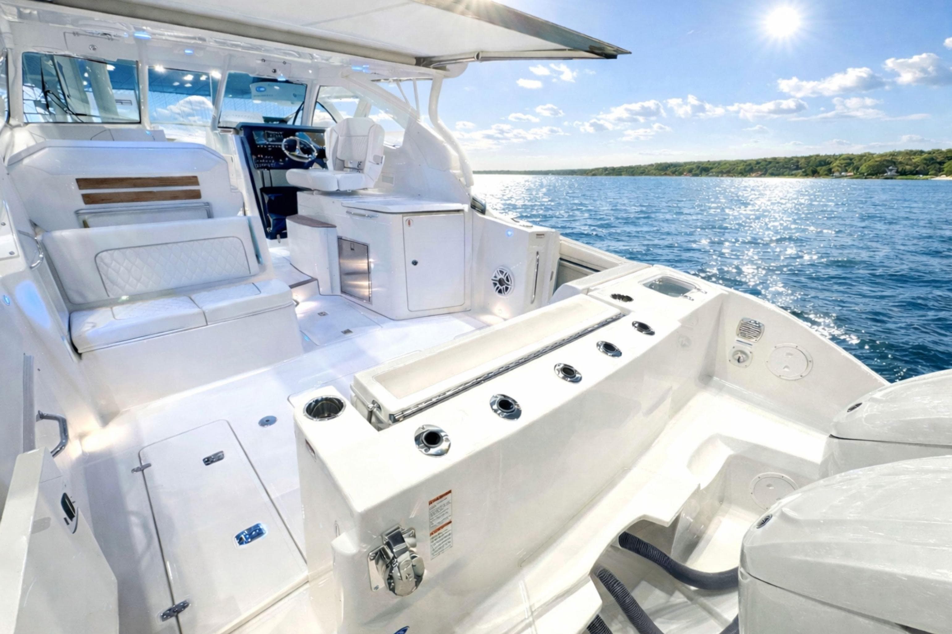 2026 Pursuit DC 365 Dual Console boat interior on sunny day, featuring luxurious seating and controls.