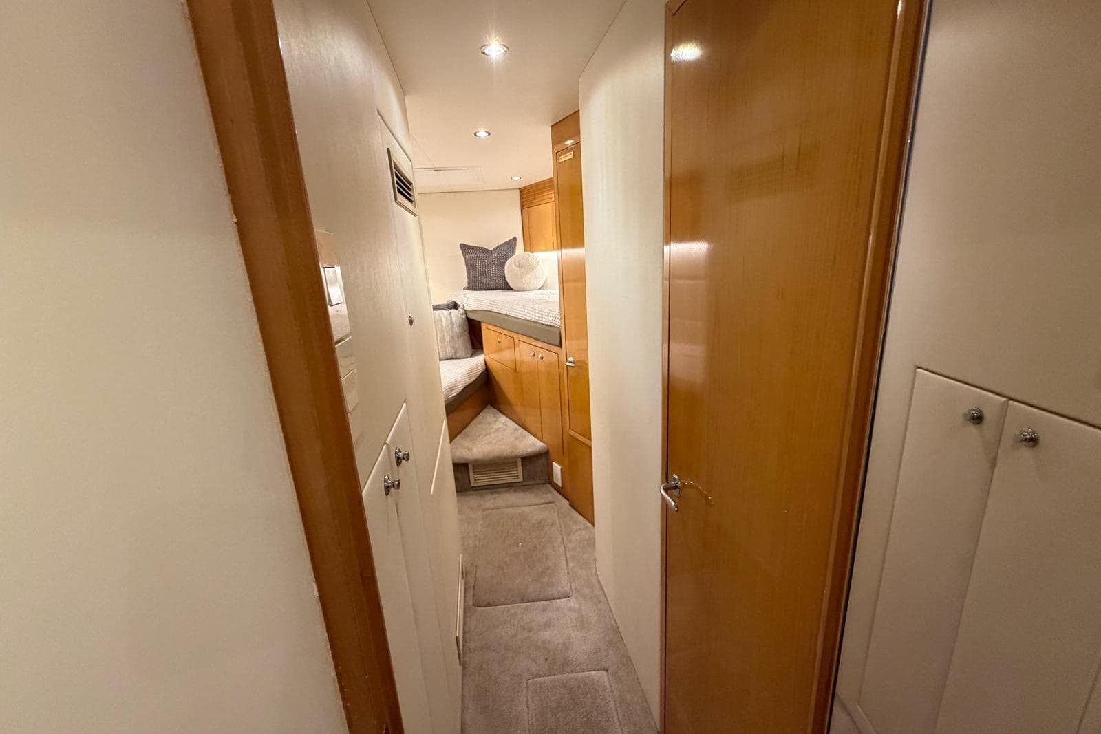 Interior hallway of 2003 Hatteras 54 Convertible yacht with cozy cabin view.
