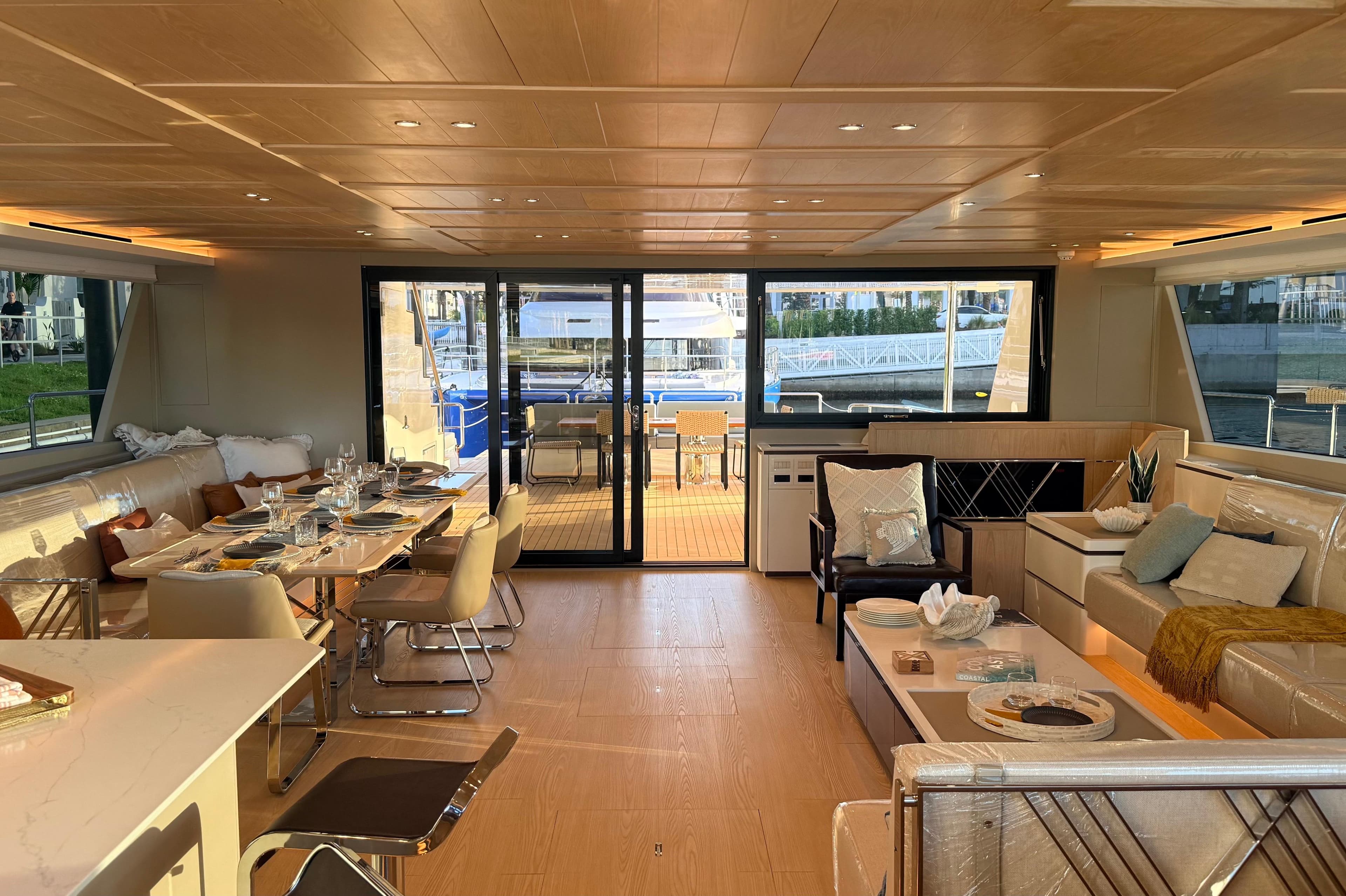 Luxurious interior of 2025 Granocean W72 yacht with elegant dining and seating areas.