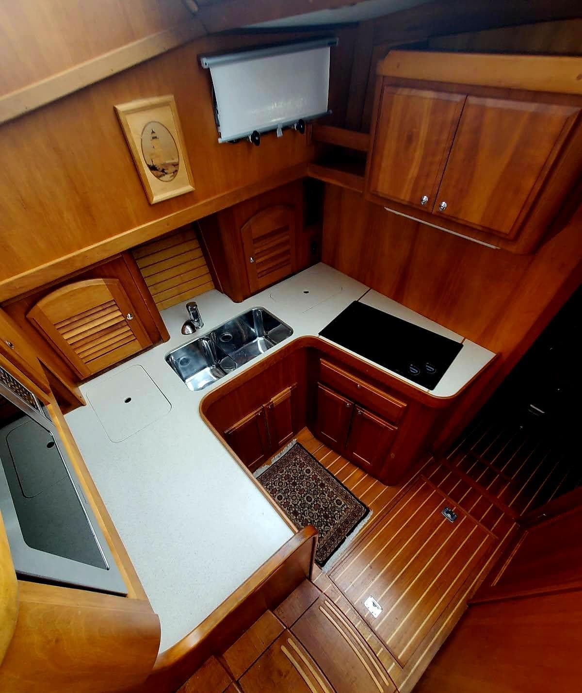 2004 Sabre 36 Flybridge Fast Trawler kitchen with wood cabinetry and modern appliances.