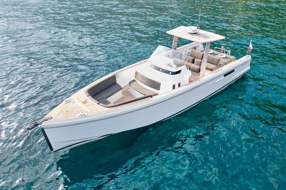 2017 Fjord 36 boat on clear blue water, showcasing sleek design and spacious deck.