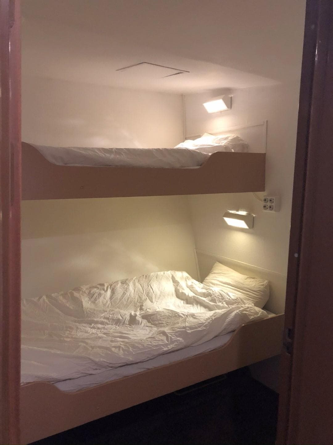 Bunk beds in a cozy cabin aboard a Classic 1896 29m Converted Icebreaker.