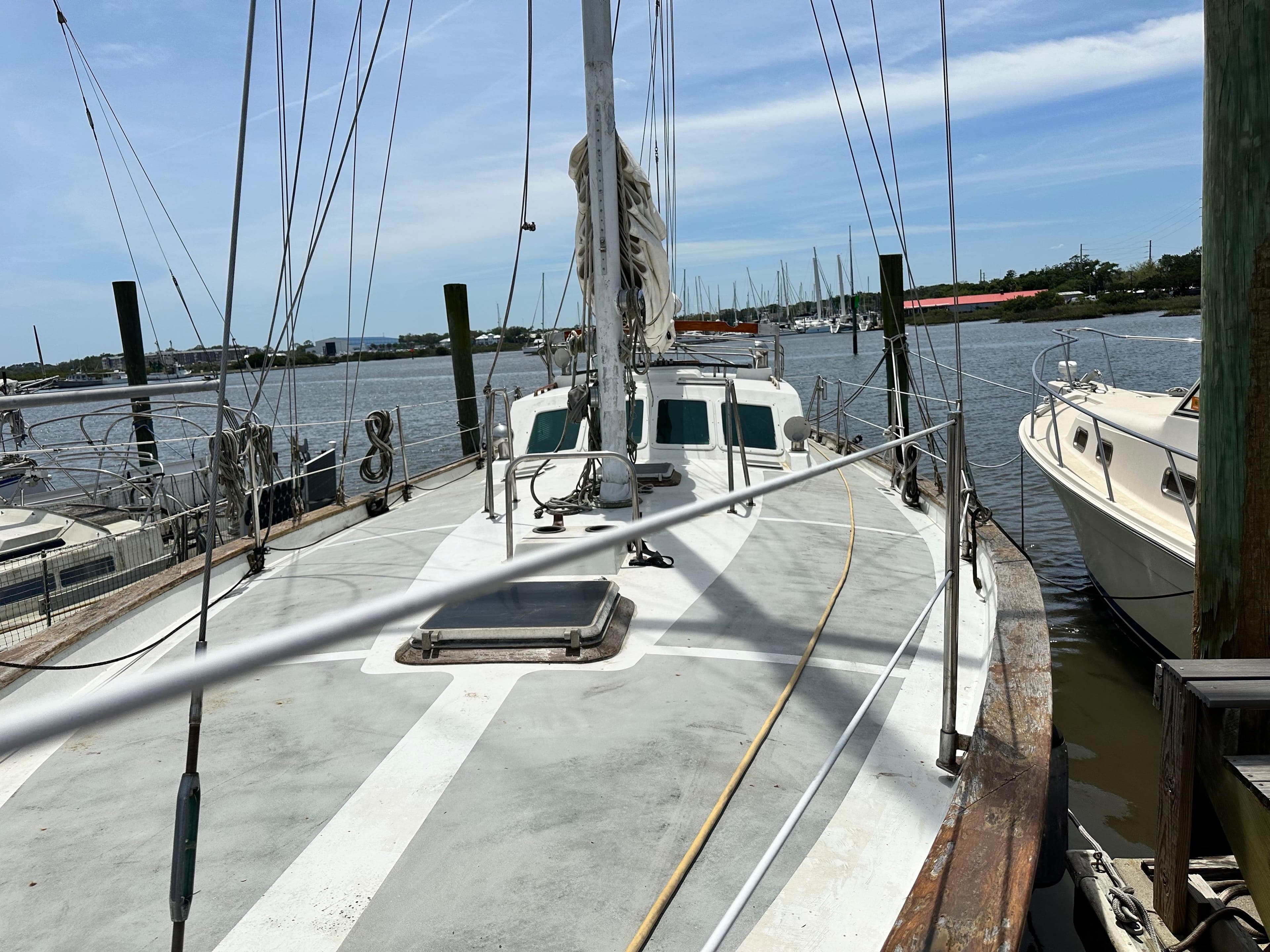 1982 Pan Oceanic 43 sailboat docked at a marina, clear sky, calm waters.