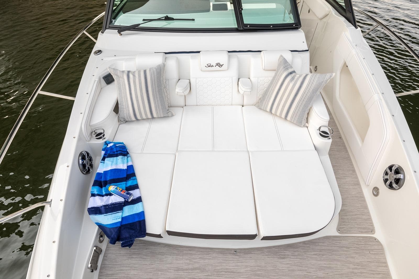Luxurious 2025 Sea Ray Sundancer 320 boat interior with plush seating and striped pillows.