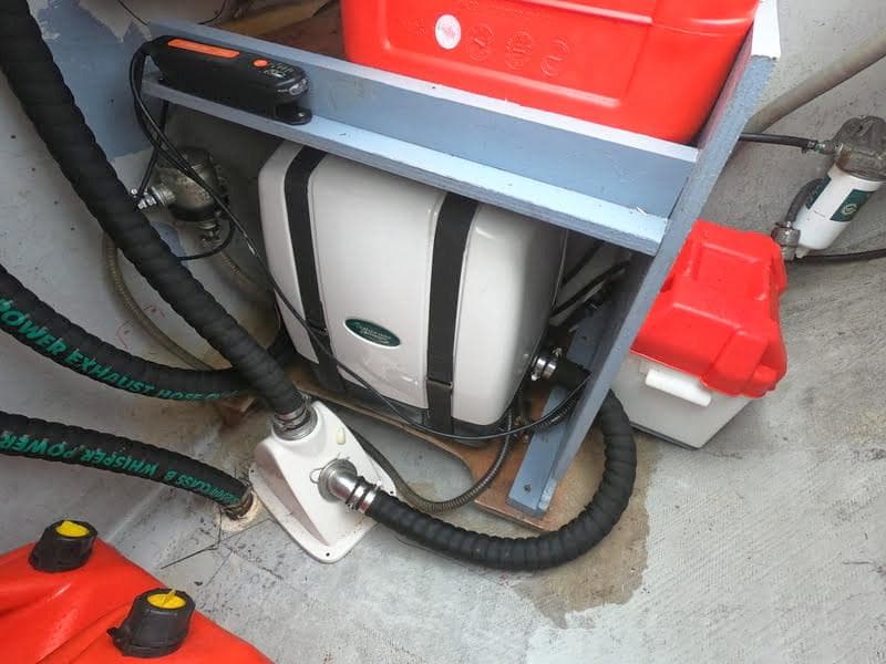 Engine compartment of a 2012 Lagoon 380 catamaran with hoses and equipment.