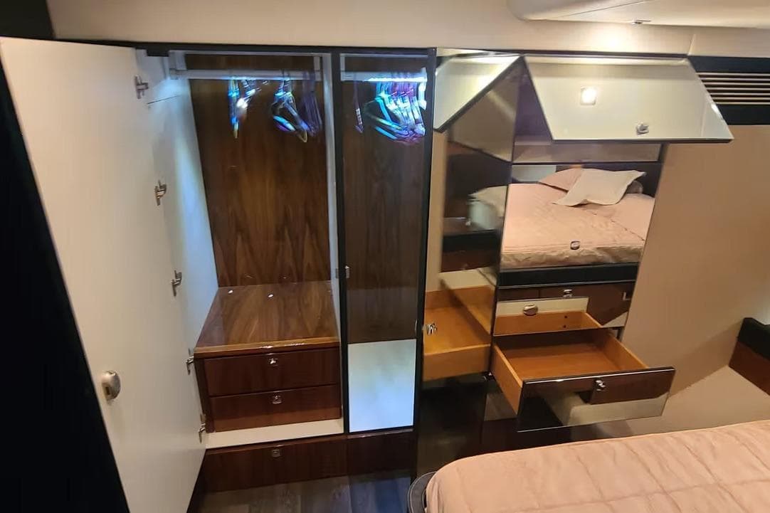 Luxurious interior of 2009 Fairline Squadron 55 yacht with wooden cabinetry and mirrored surfaces.