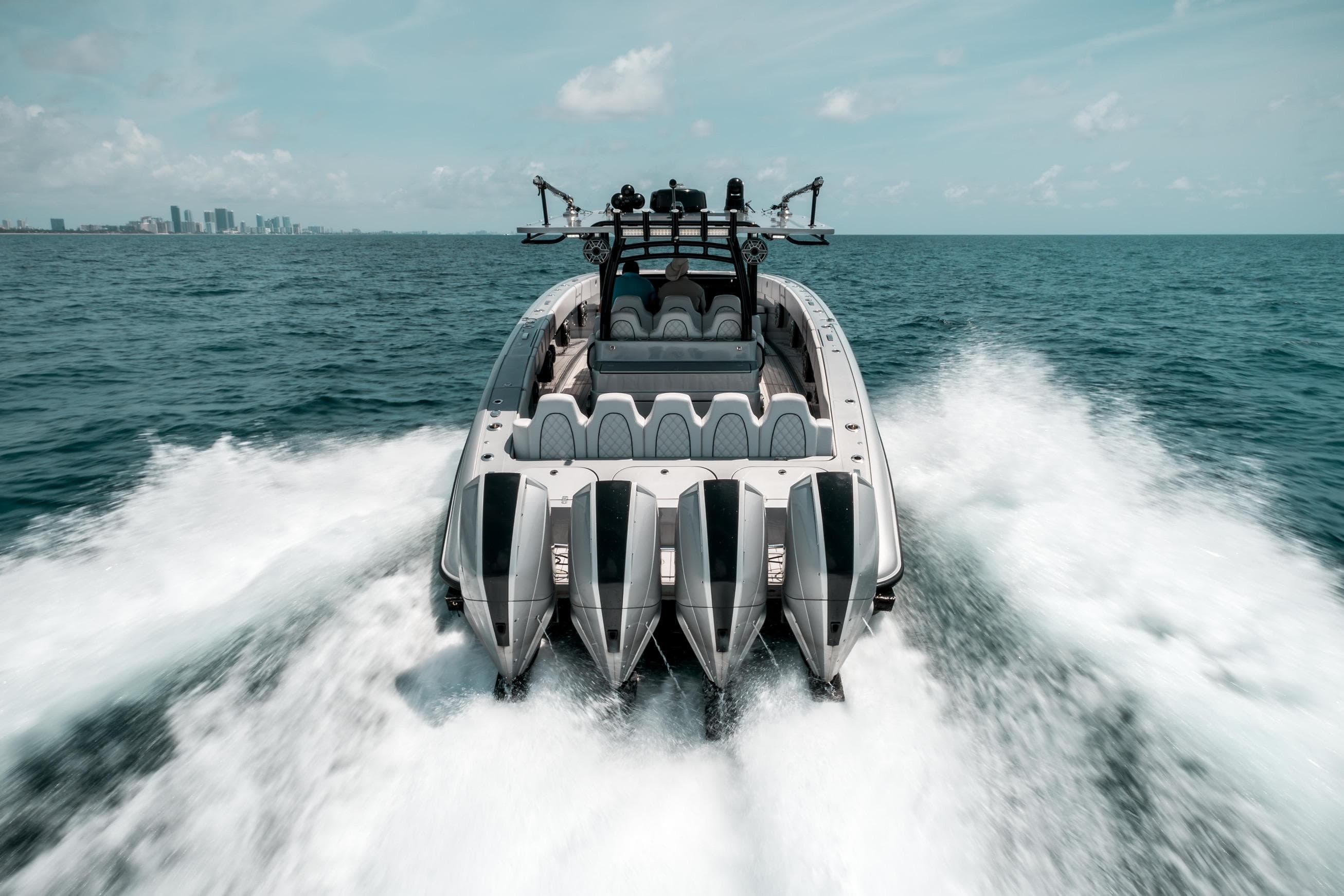 2022 Midnight Express 43 Open boat cruising on ocean with city skyline in background.