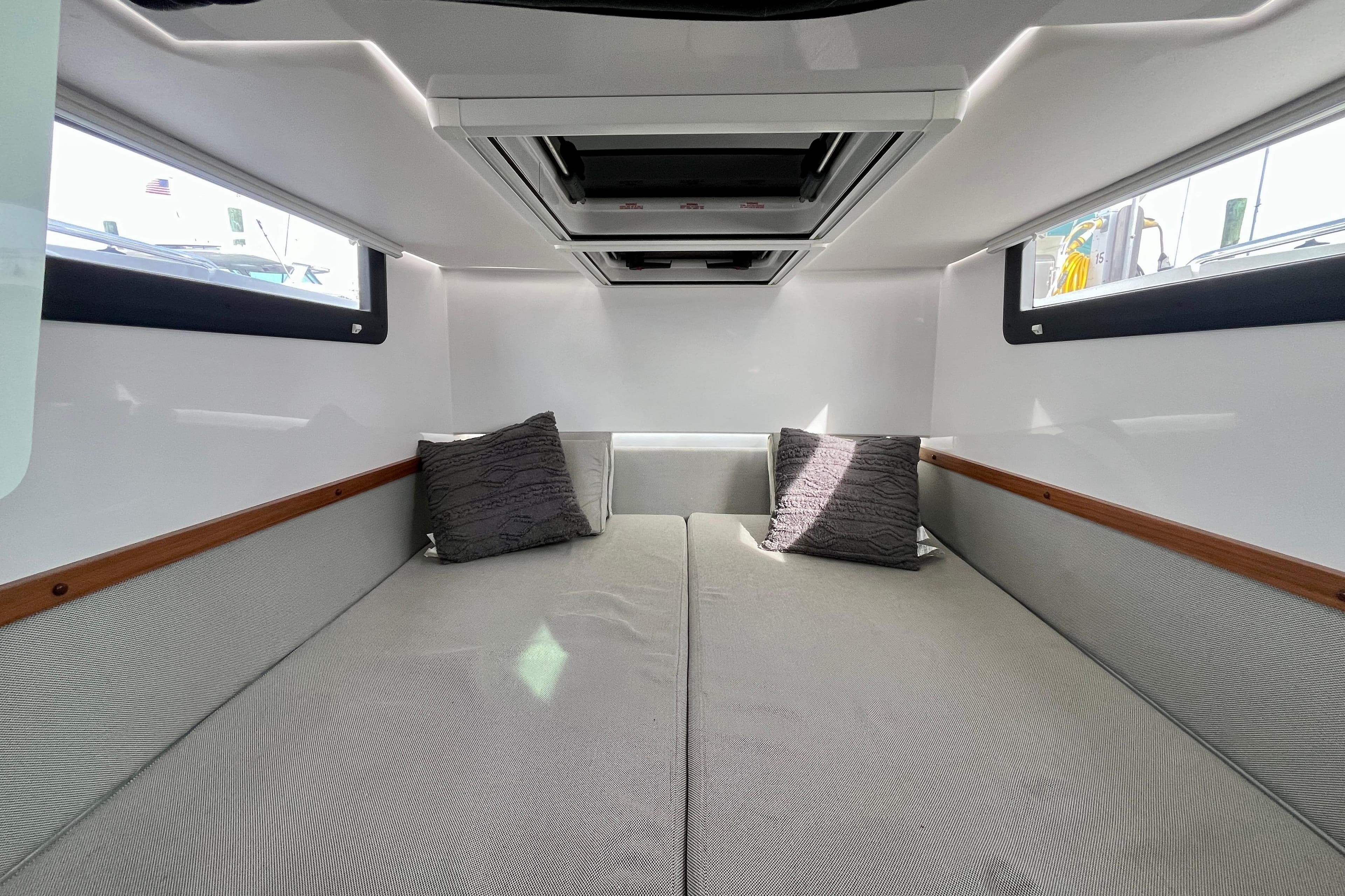 2018 Axopar 37 Sport Cabin R interior with cozy bed and pillows.
